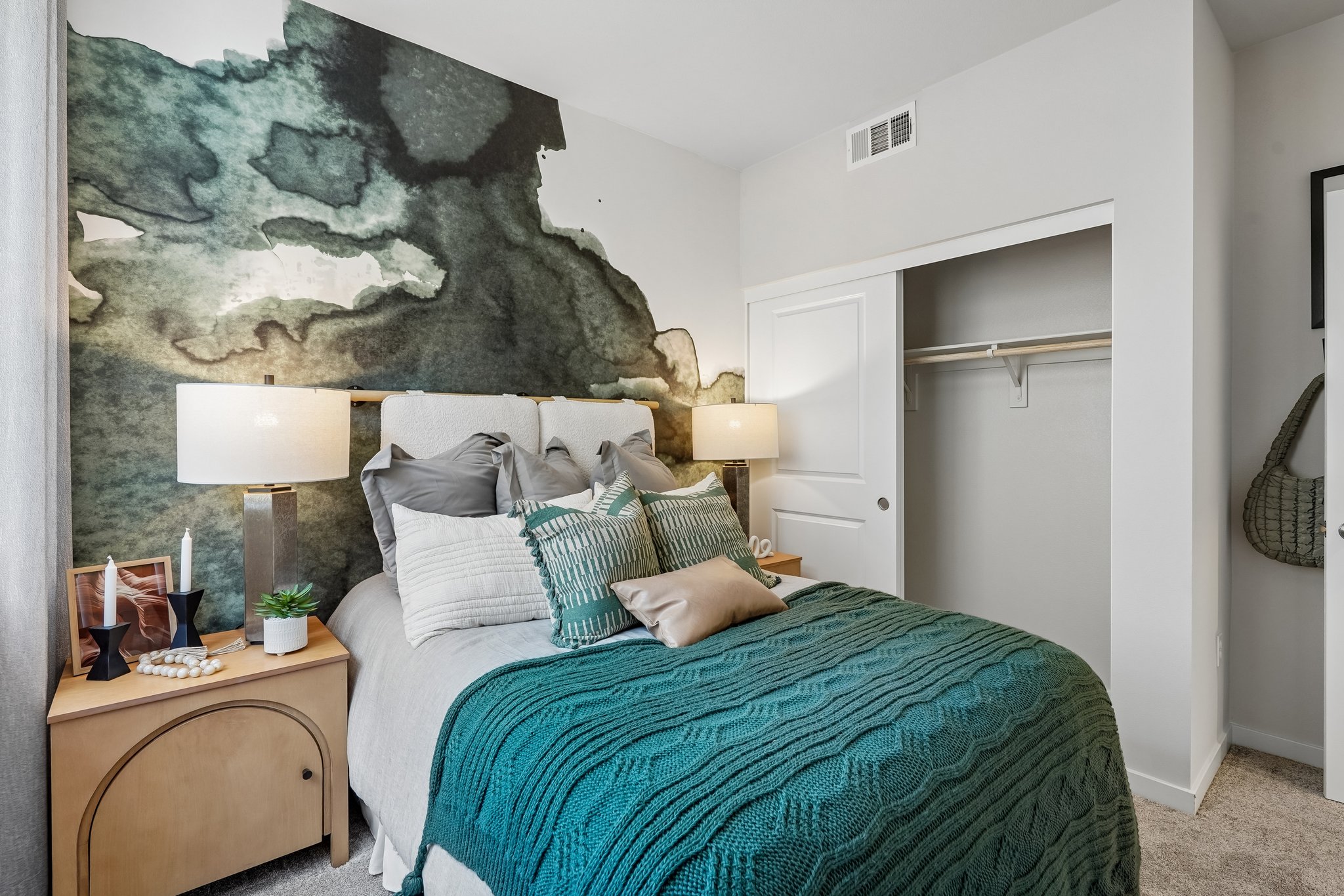 A bedroom with a large rock wall.