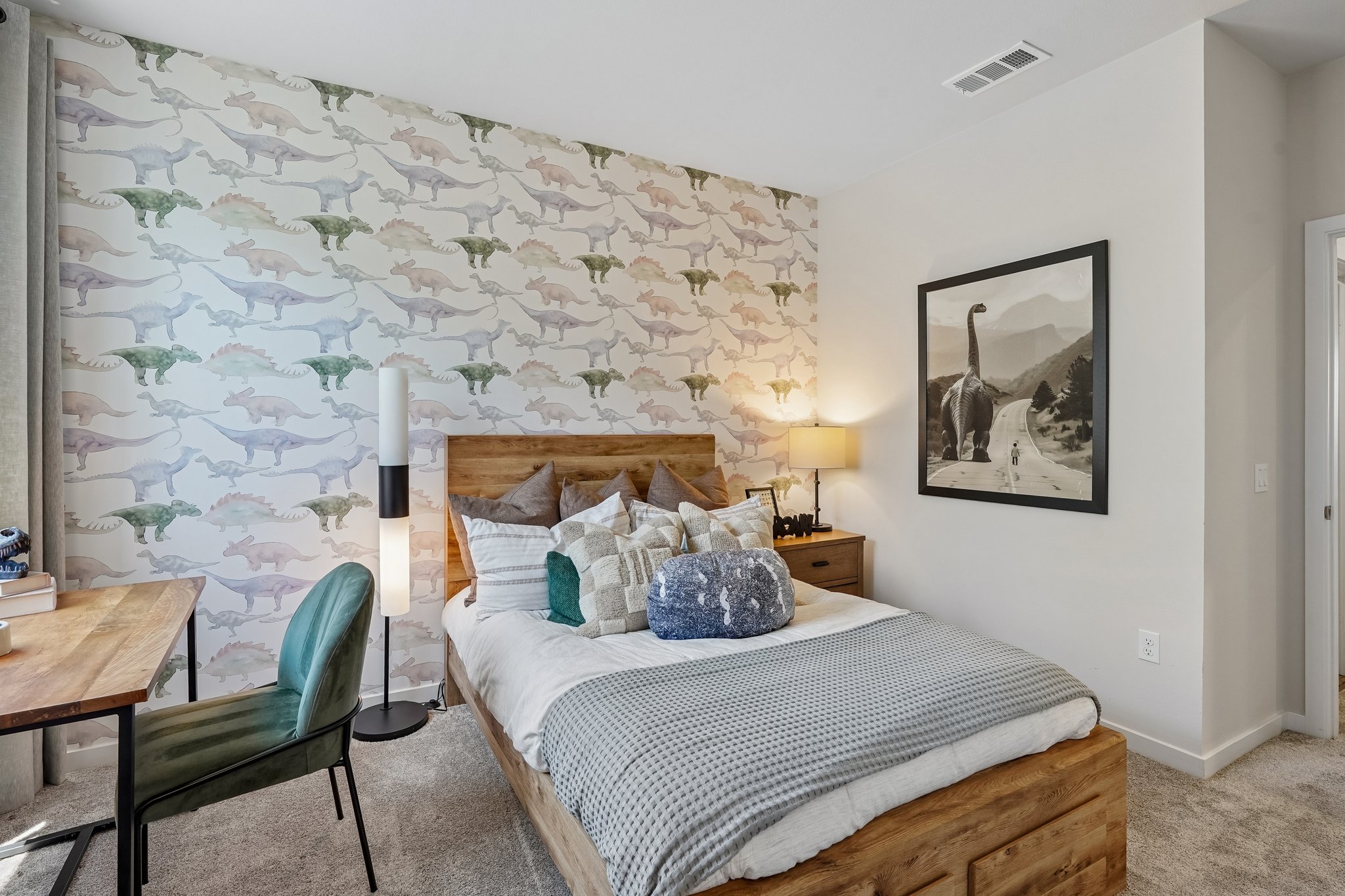 A bed with a flowered wallpaper.