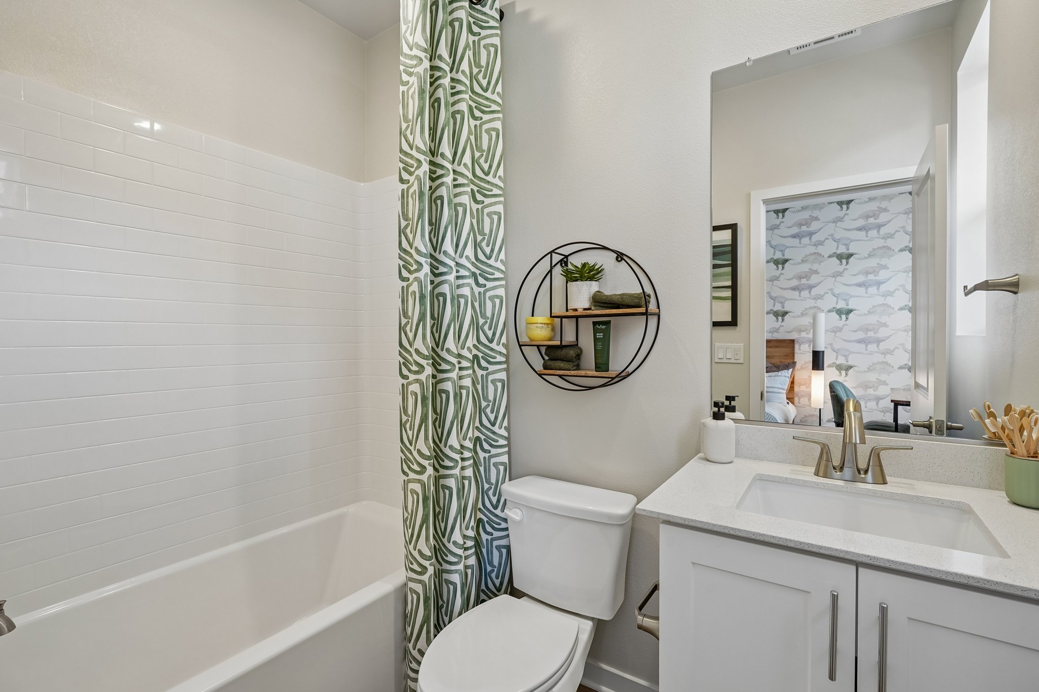 A bathroom with a tub sink and toilet.