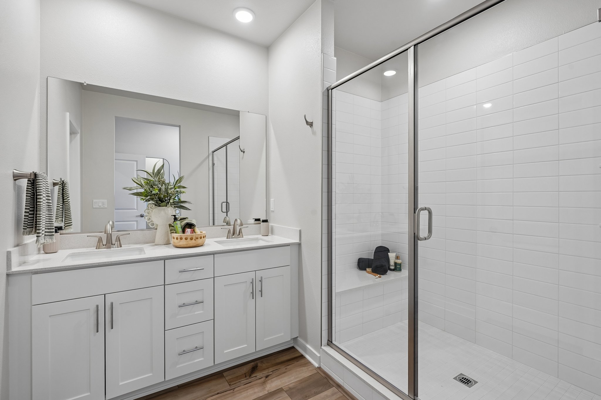 A bathroom with white cabinets.