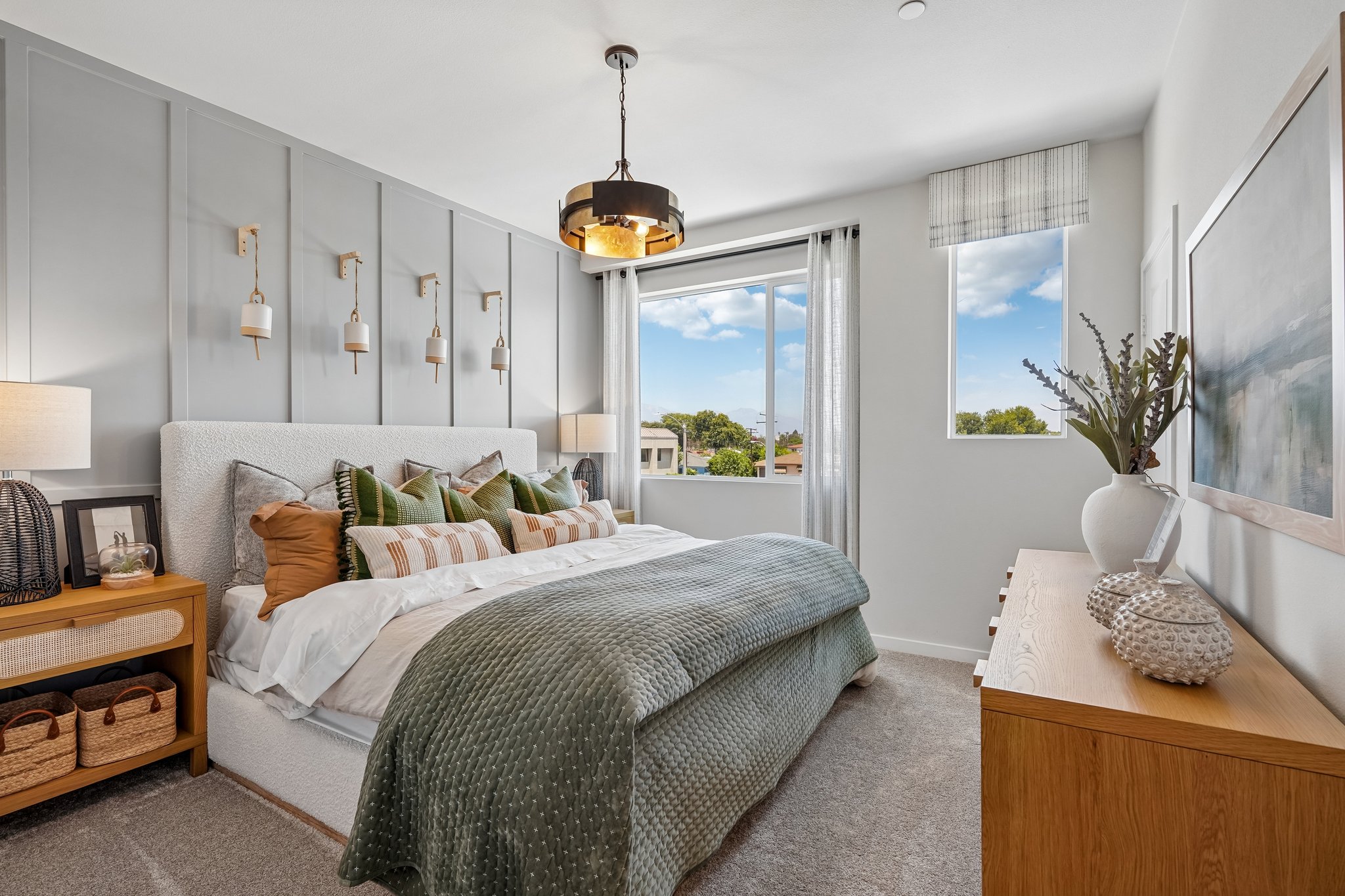 A bedroom with a large window.