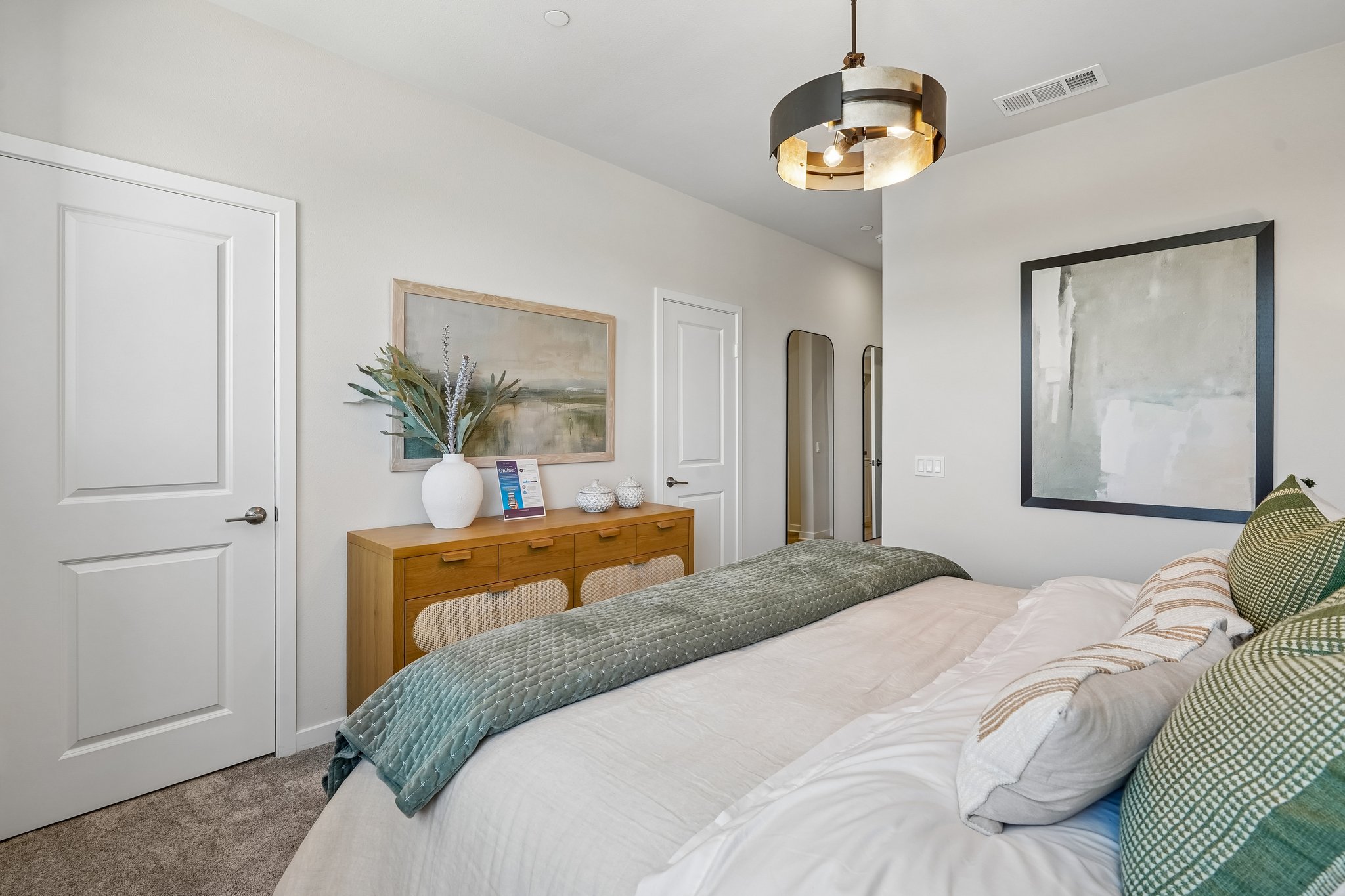 A bedroom with a bed and a table.