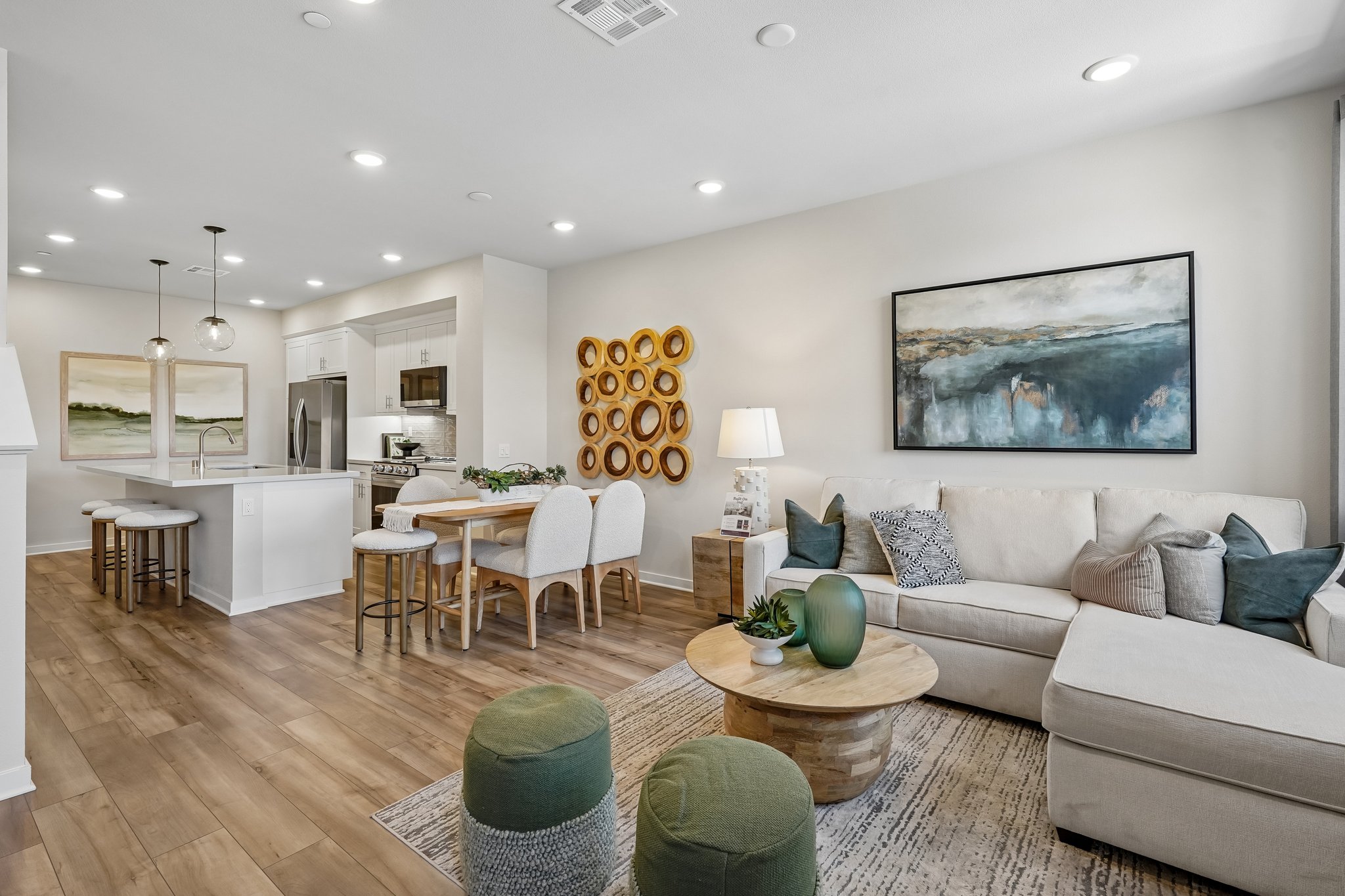 A living room with a large dining room and a large painting.