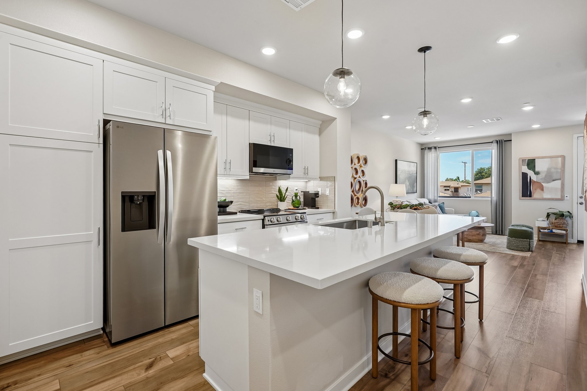 A kitchen with white cabinets.