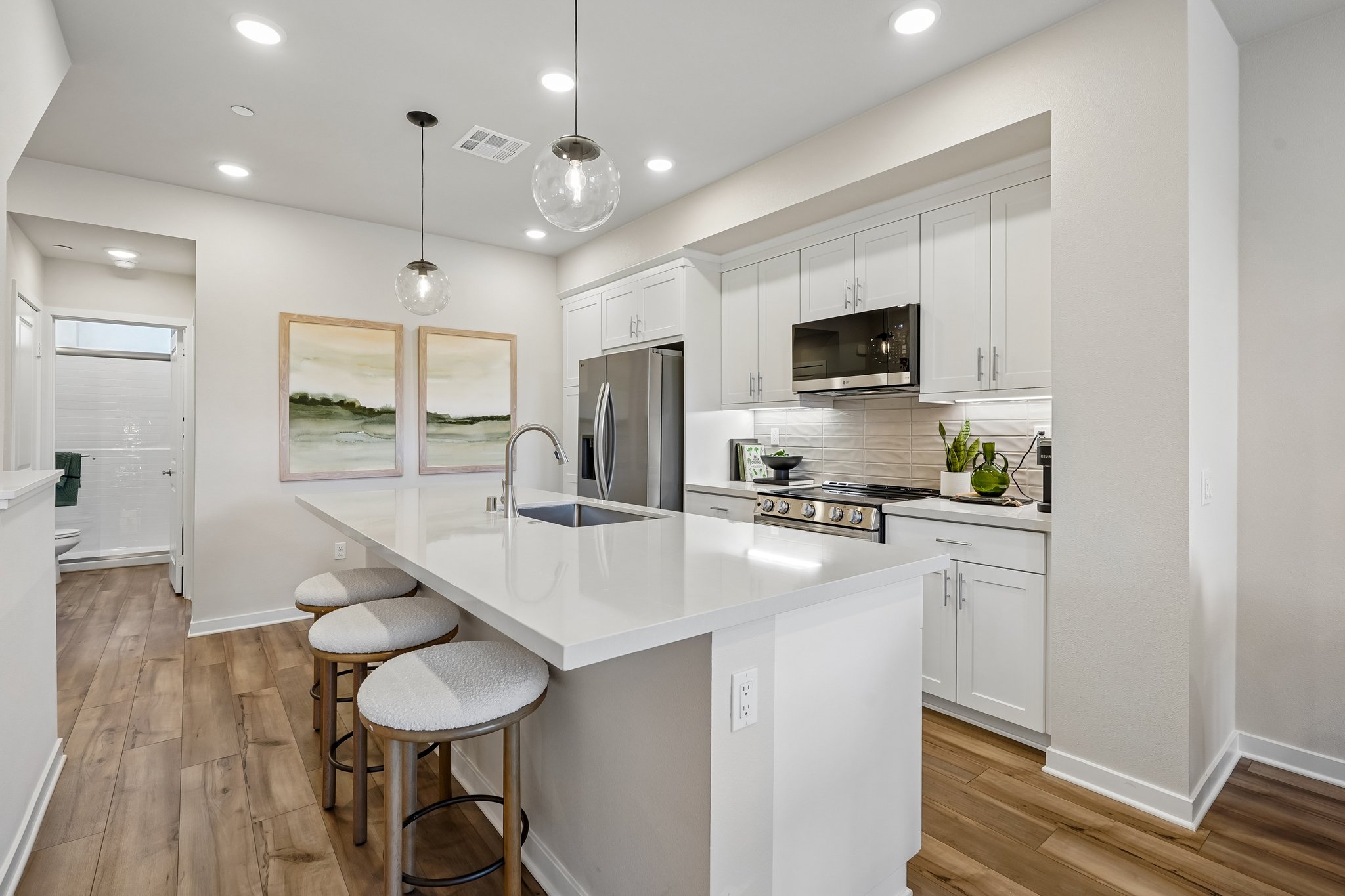 A kitchen with white cabinets.