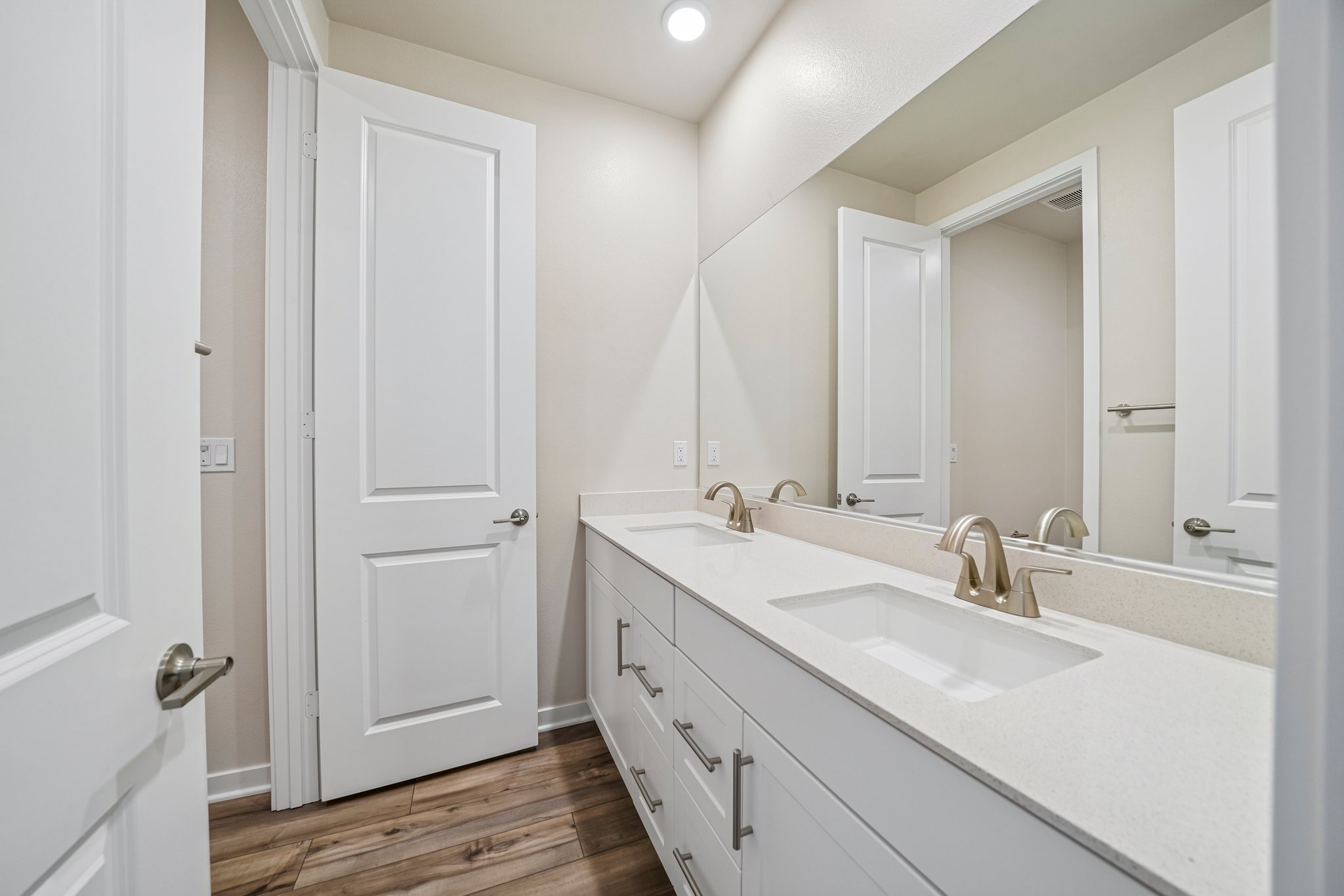 A bathroom with a large mirror.