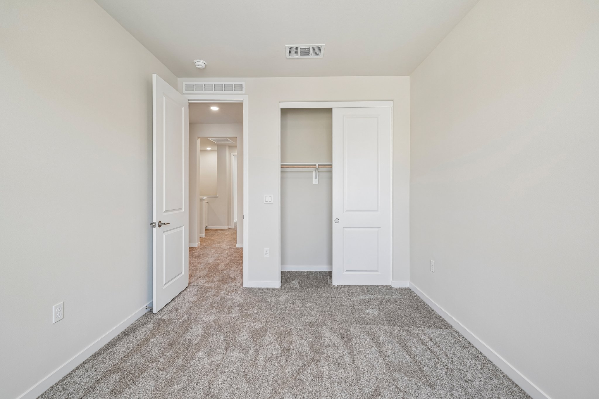 A hallway with white doors.