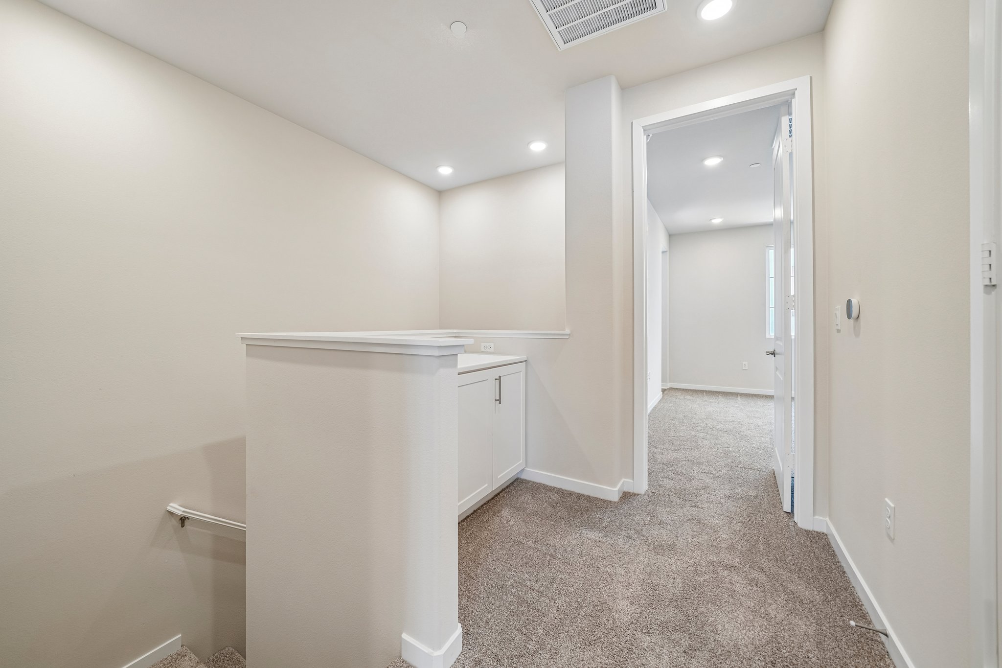 A hallway with white walls.