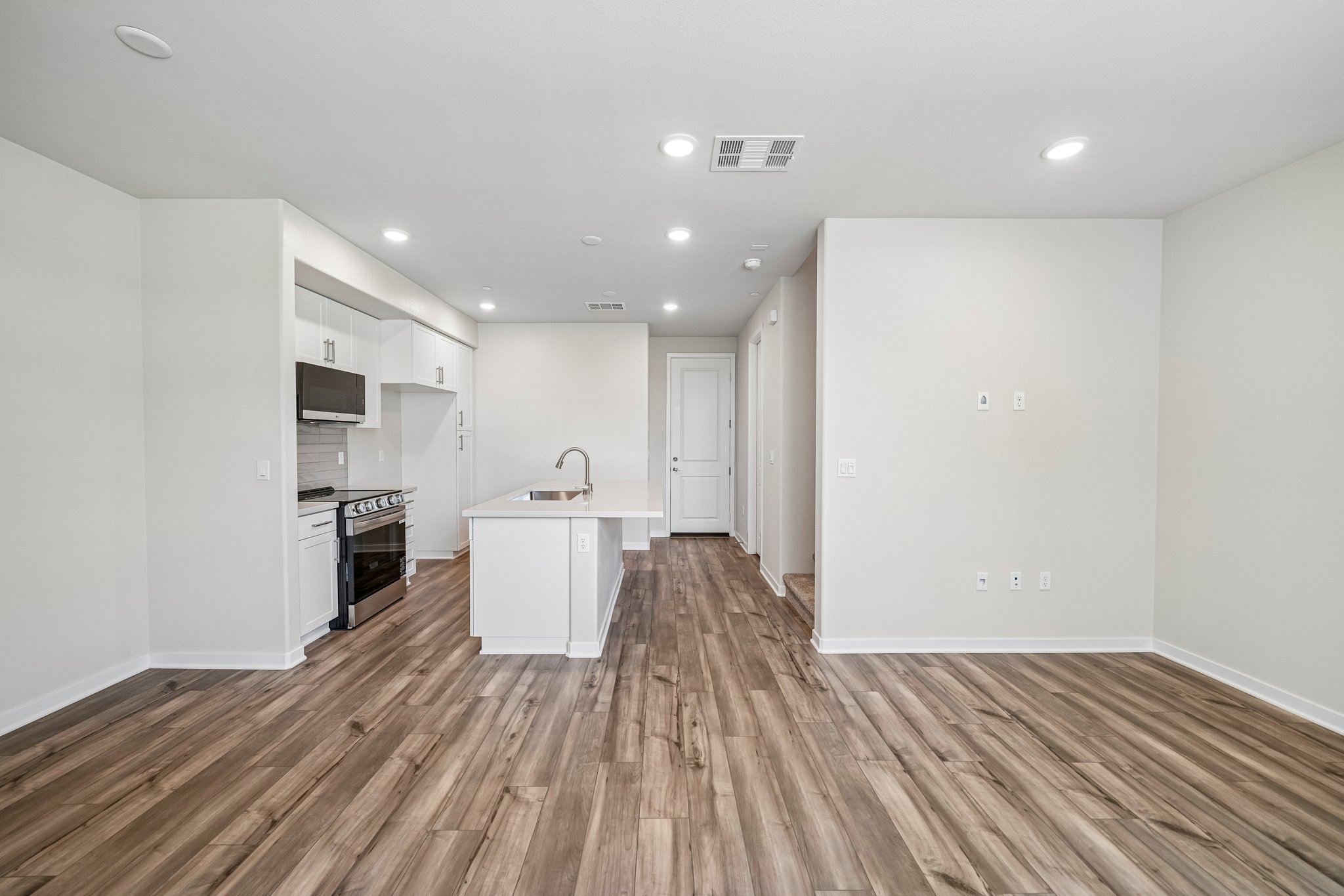 A kitchen with white walls.