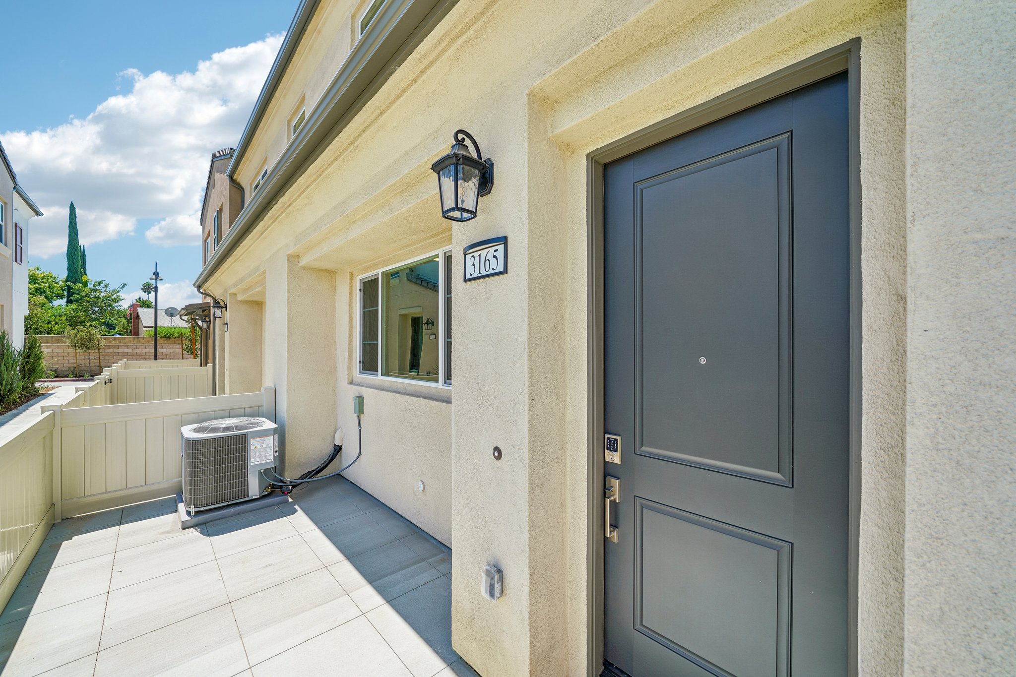 A white building with a black door.