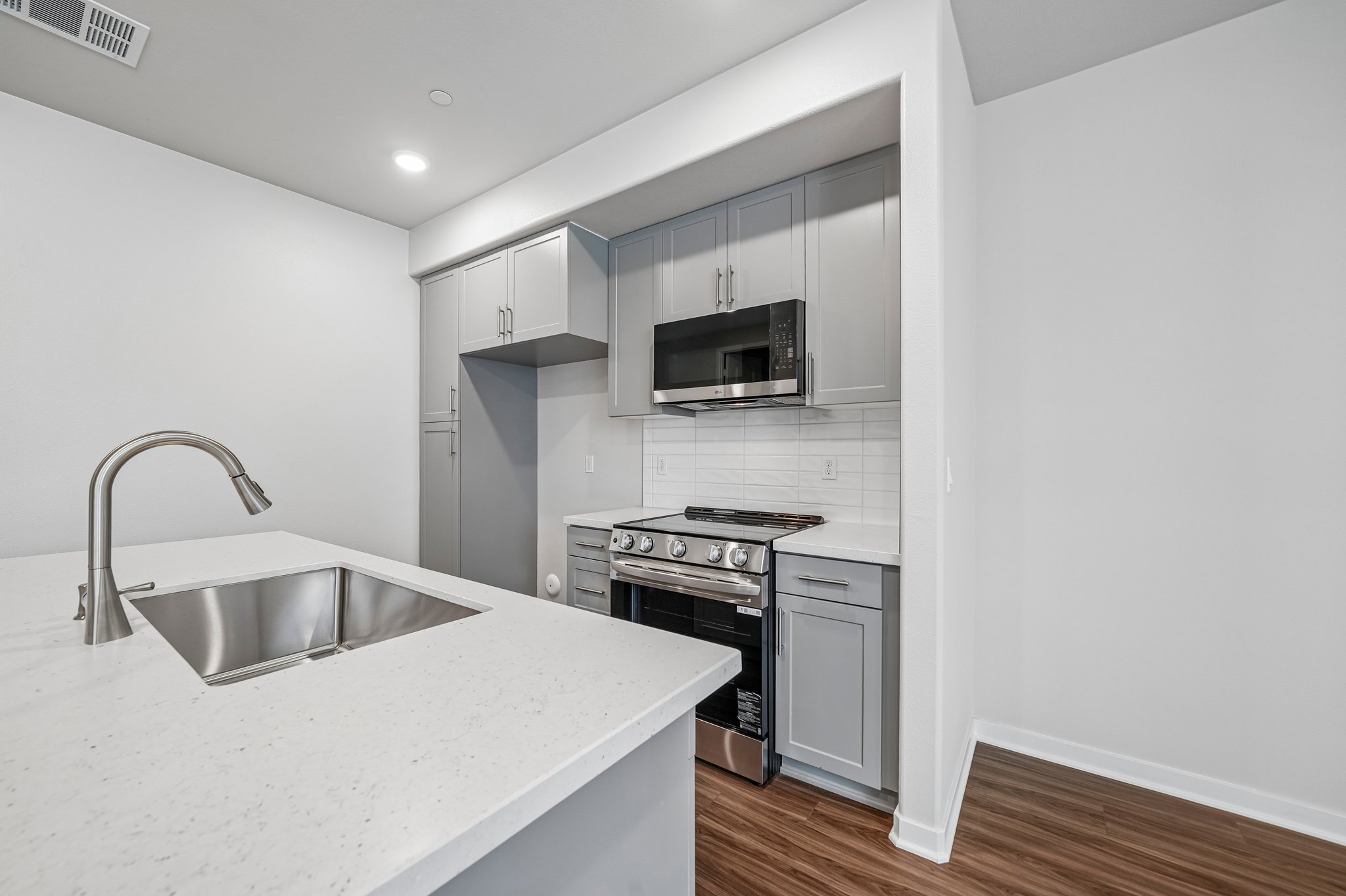 A kitchen with white cabinets.