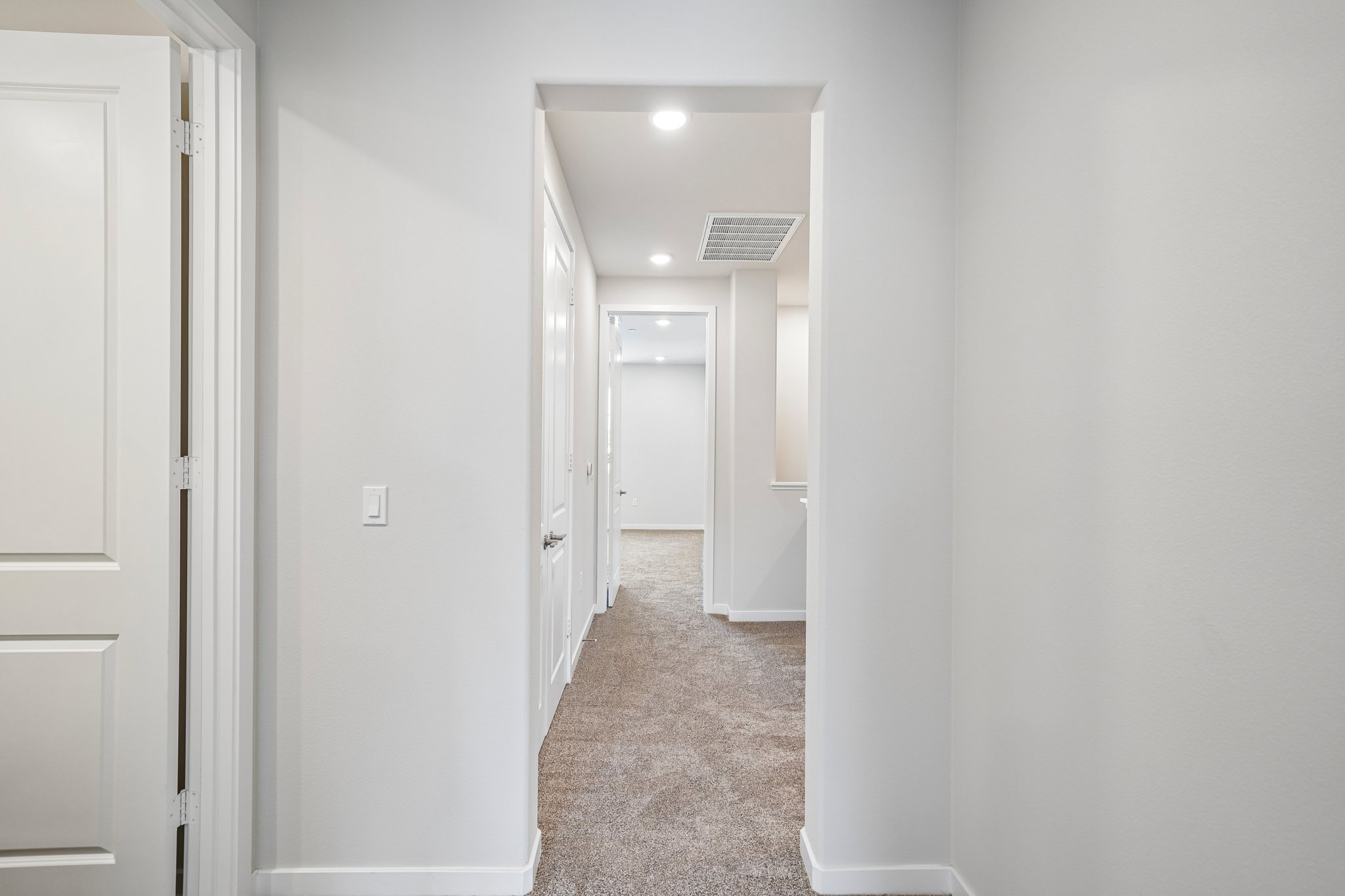 A hallway with white doors.