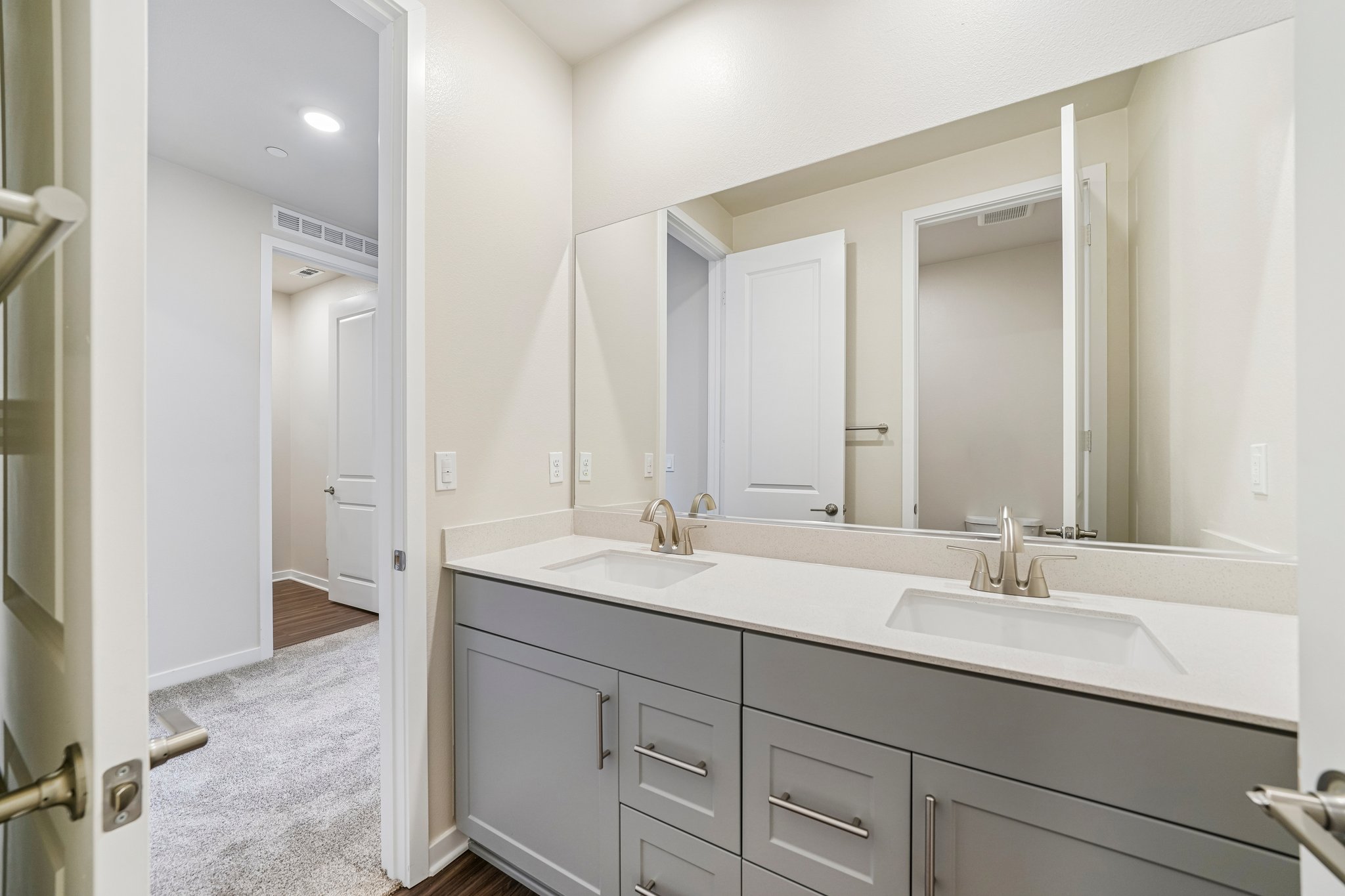A bathroom with a large mirror.