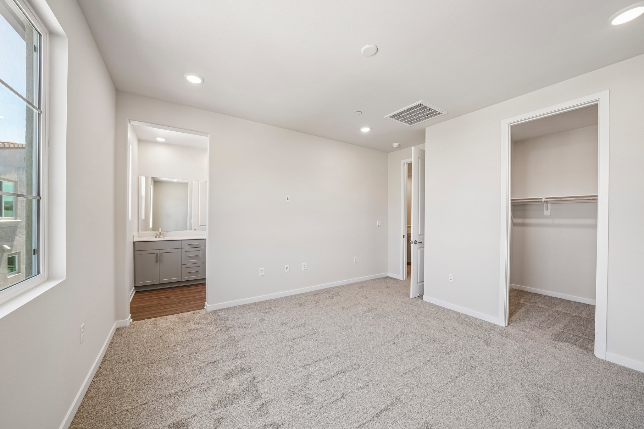 A room with a carpet and a white wall.