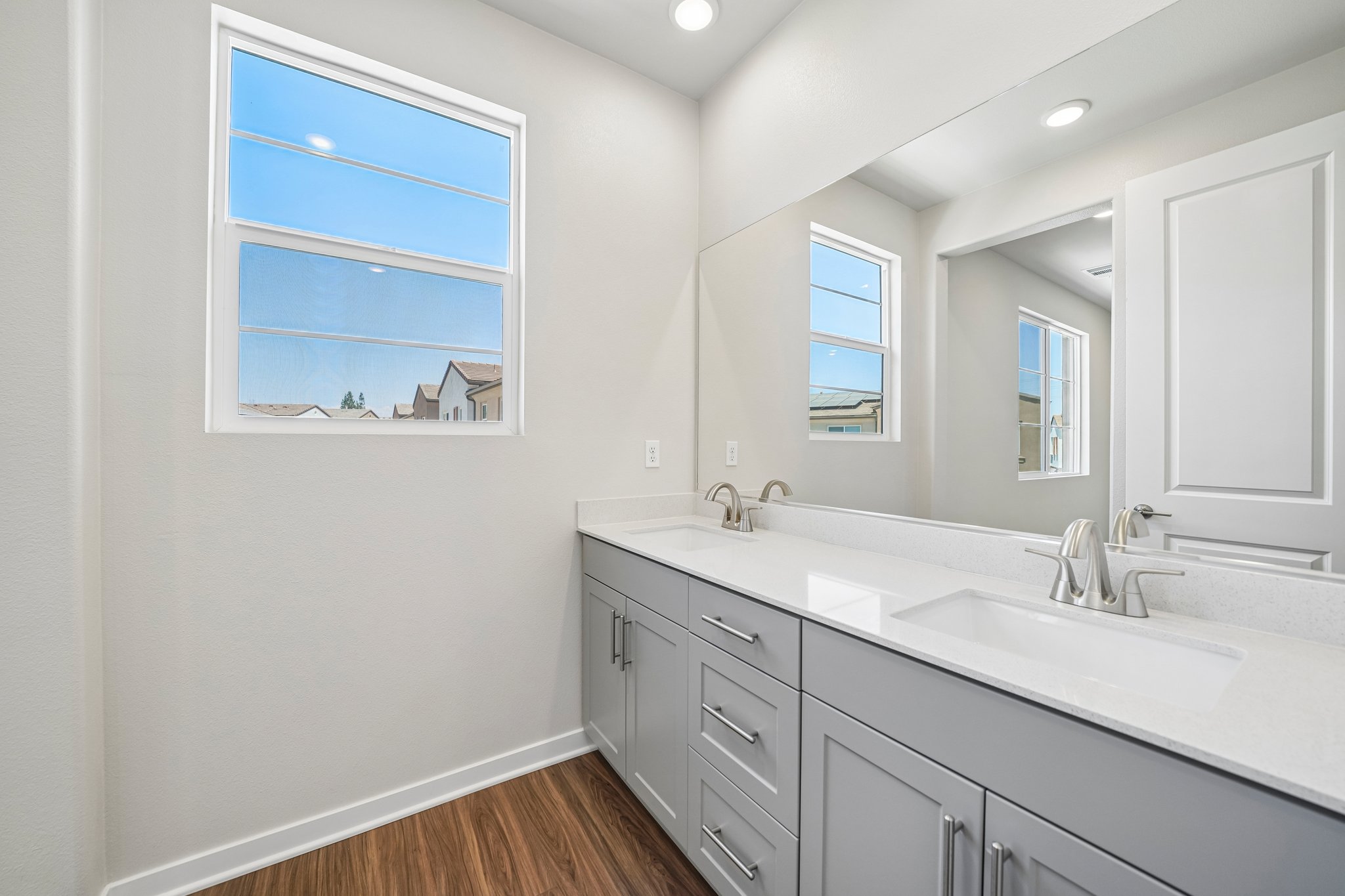A bathroom with white cabinets.