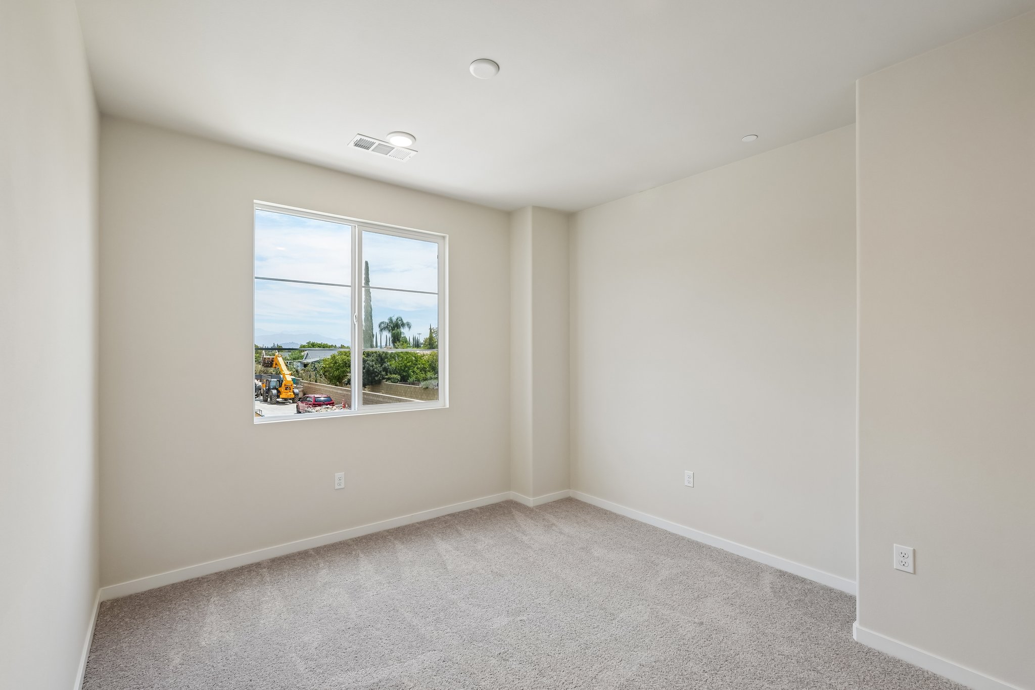 A room with a window and a carpet.