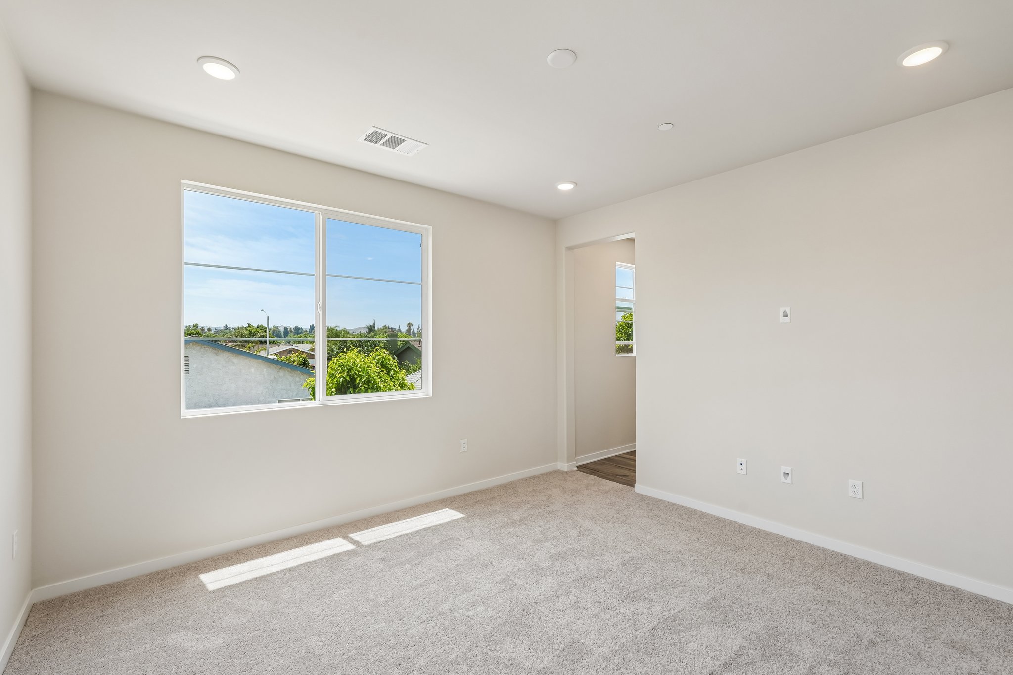 A room with a window and a view of the water.