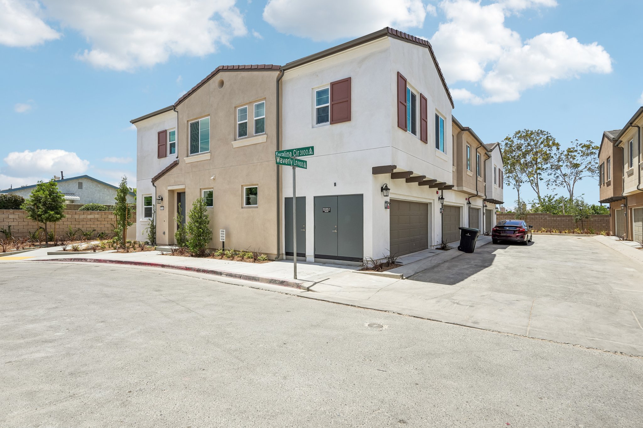 A white building with a parking lot.