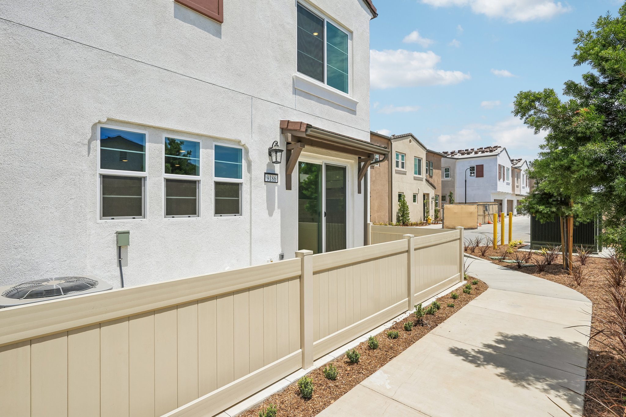 A white building with a white fence.