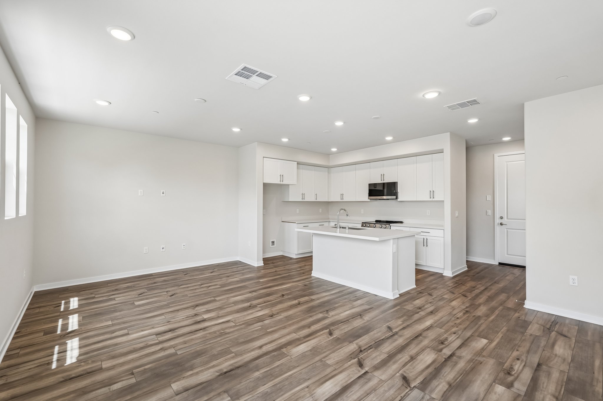 A kitchen with white cabinets.
