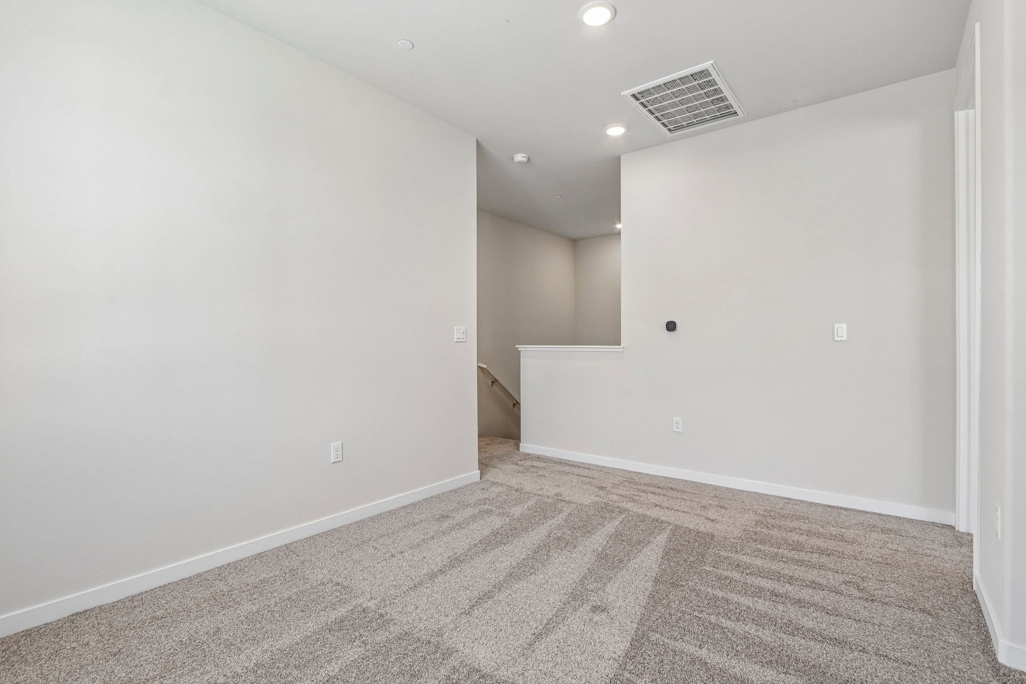 A hallway with white walls.