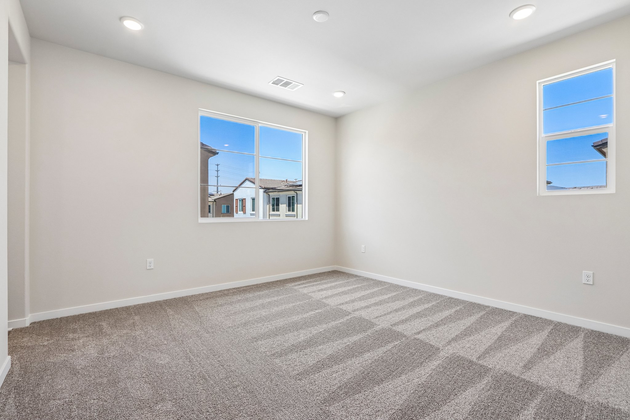 A room with a window and a carpet.