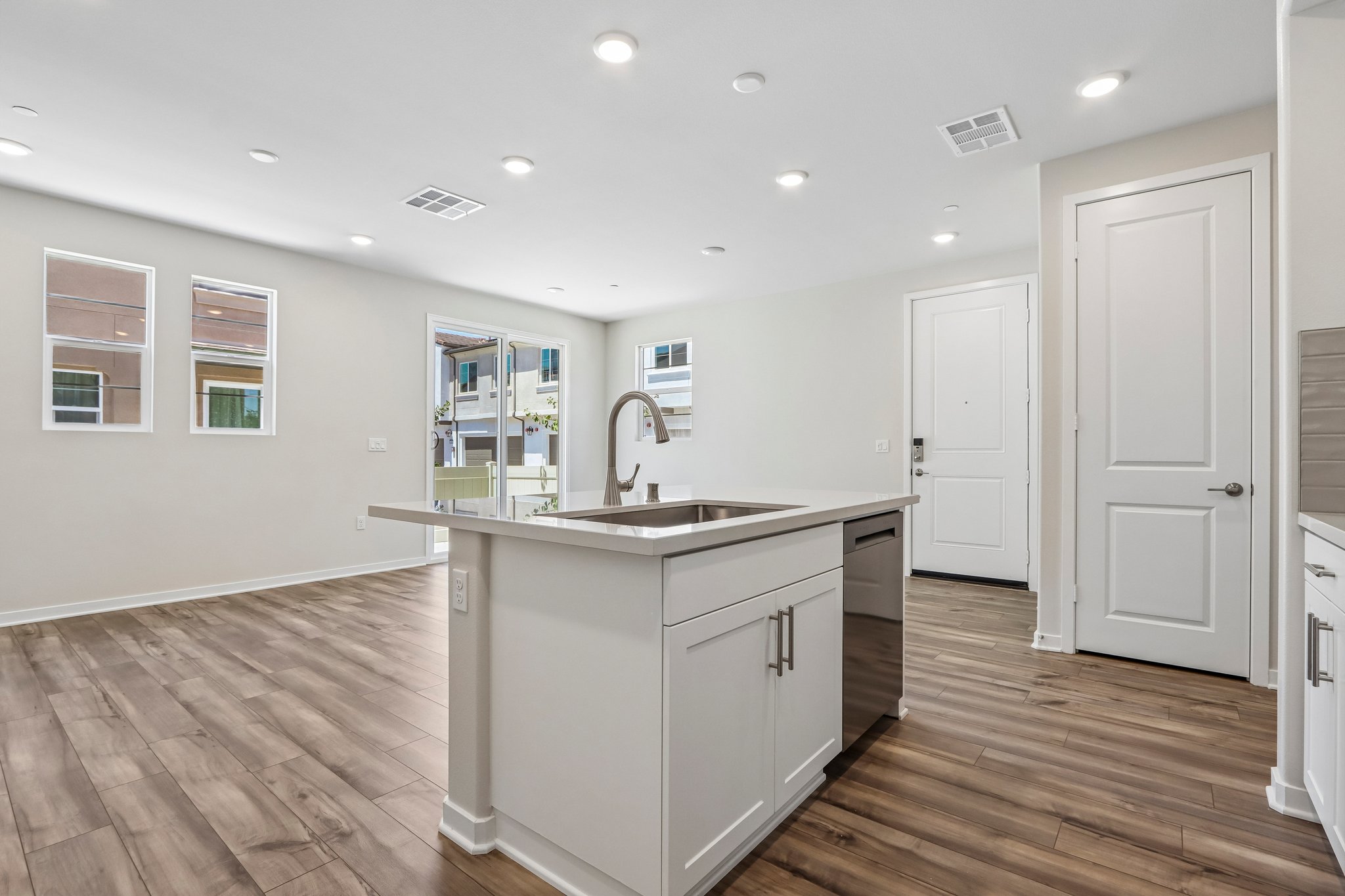 A kitchen with white cabinets.