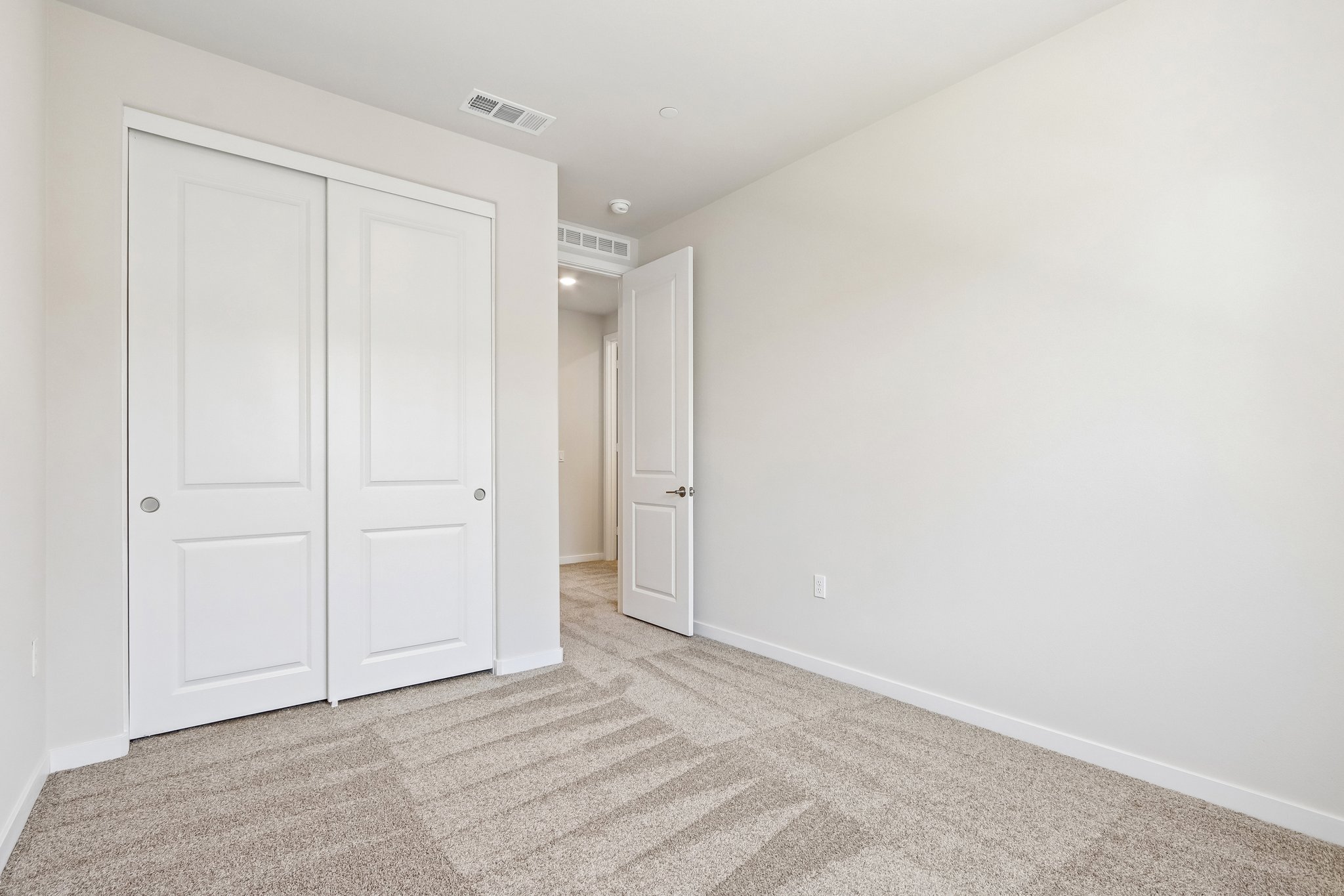 A hallway with white doors.