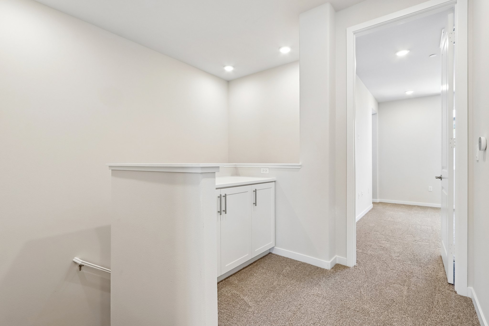 A bathroom with white walls.