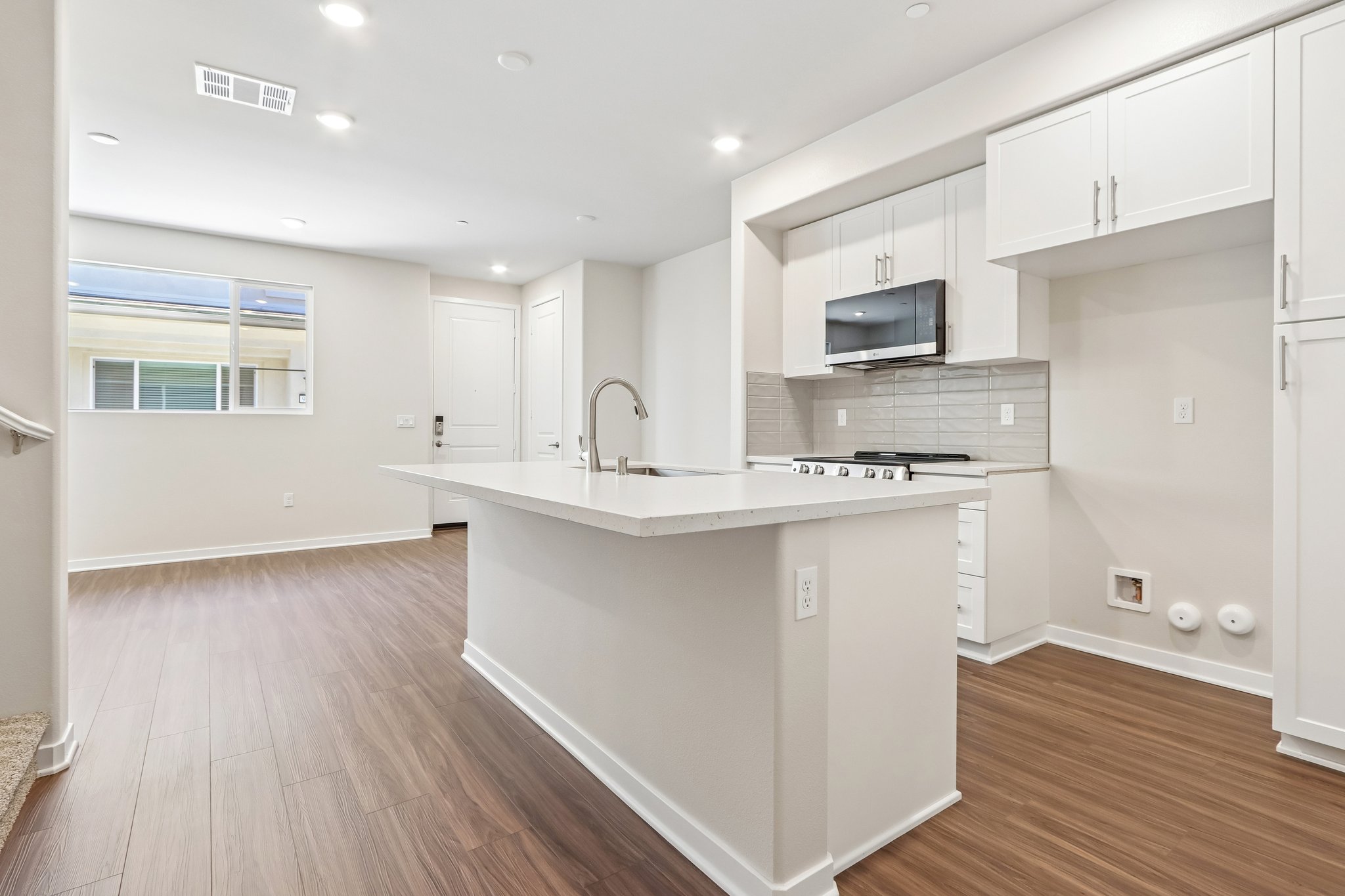 A kitchen with white cabinets.