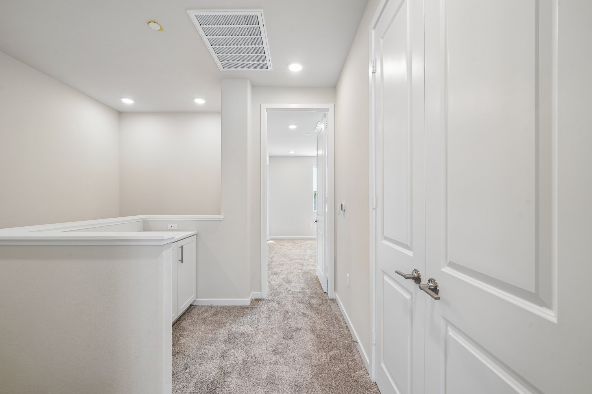 A hallway with white doors.