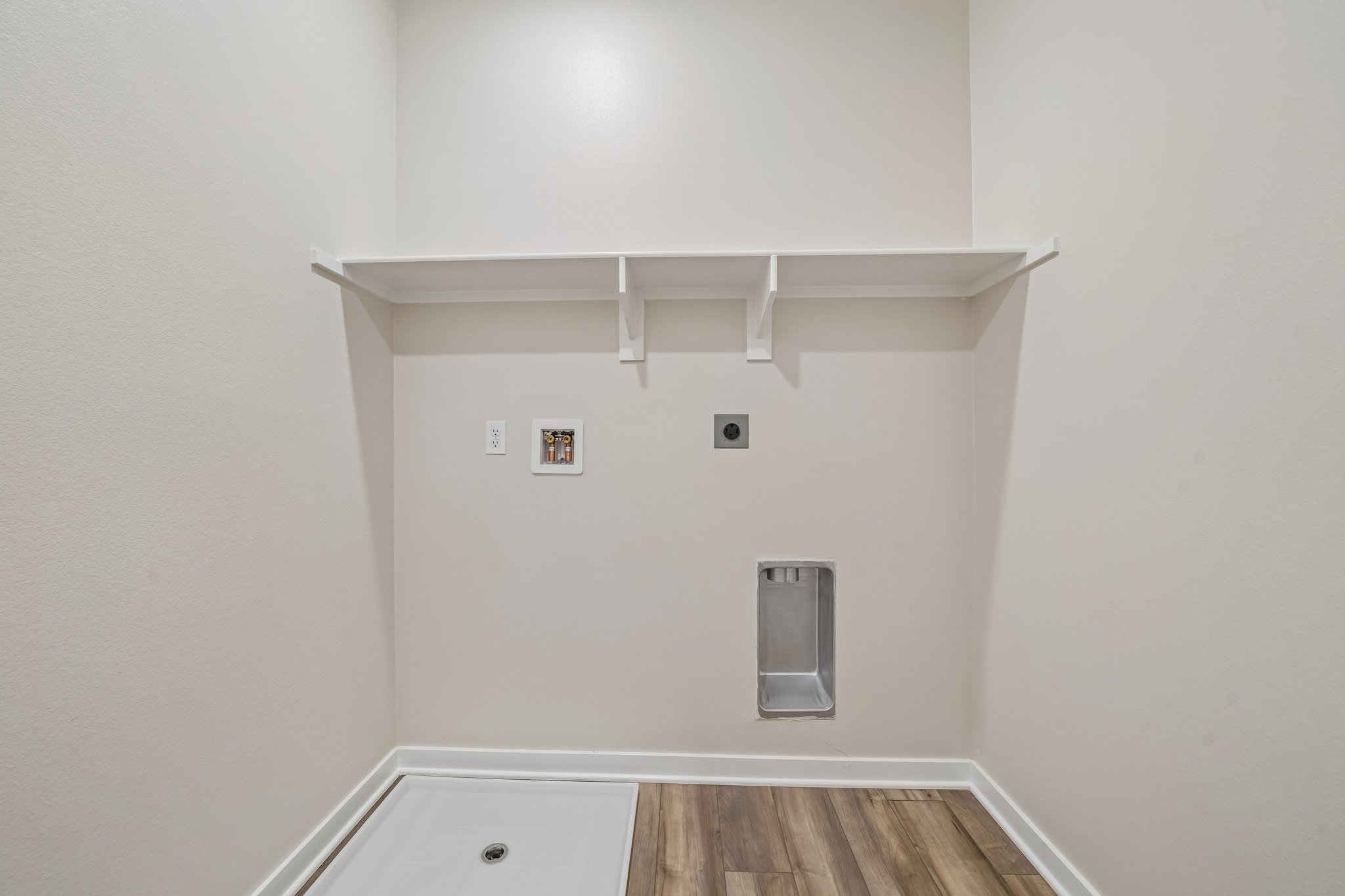 A white wall with a light fixture.
