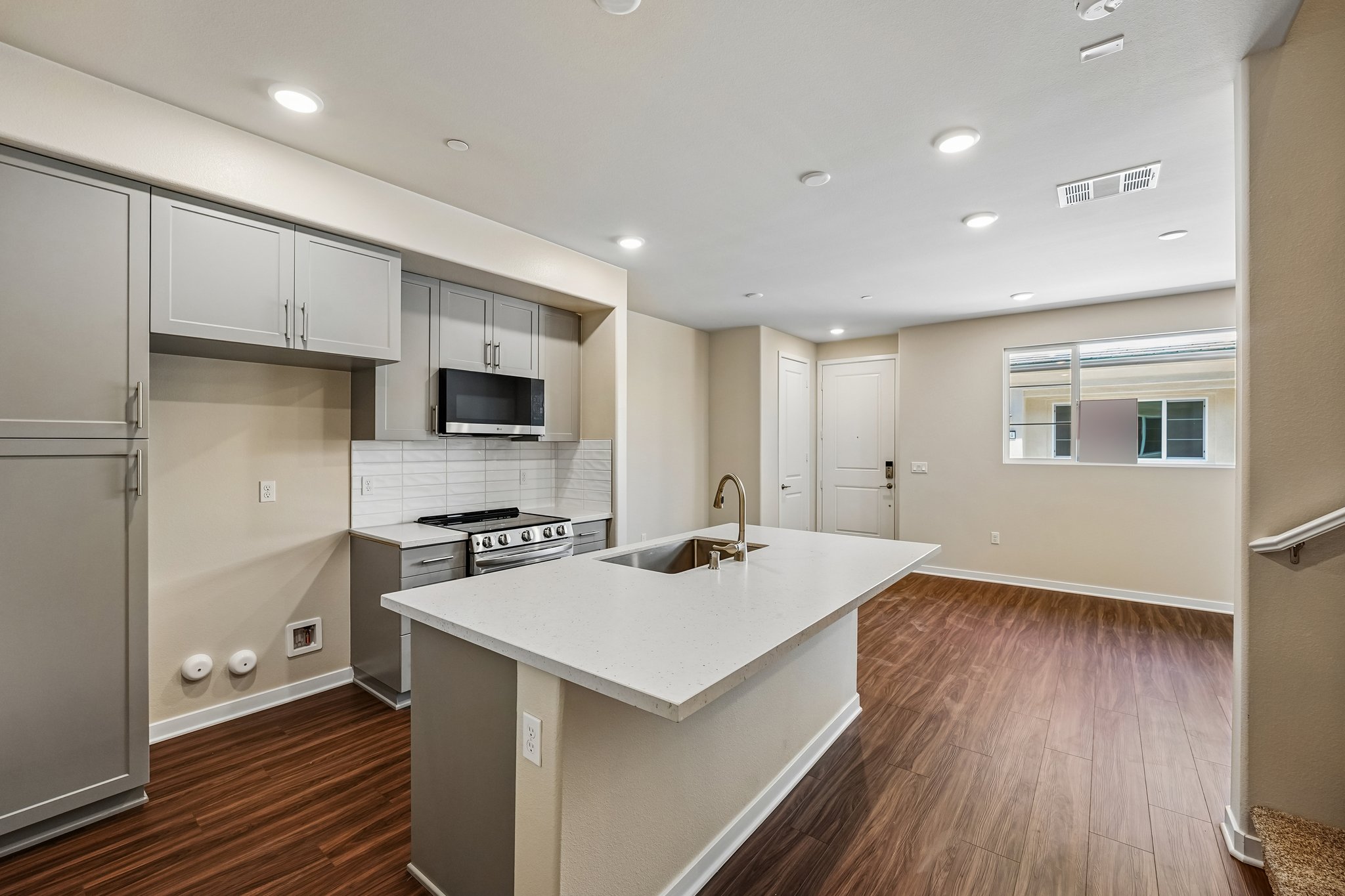 A kitchen with white cabinets.