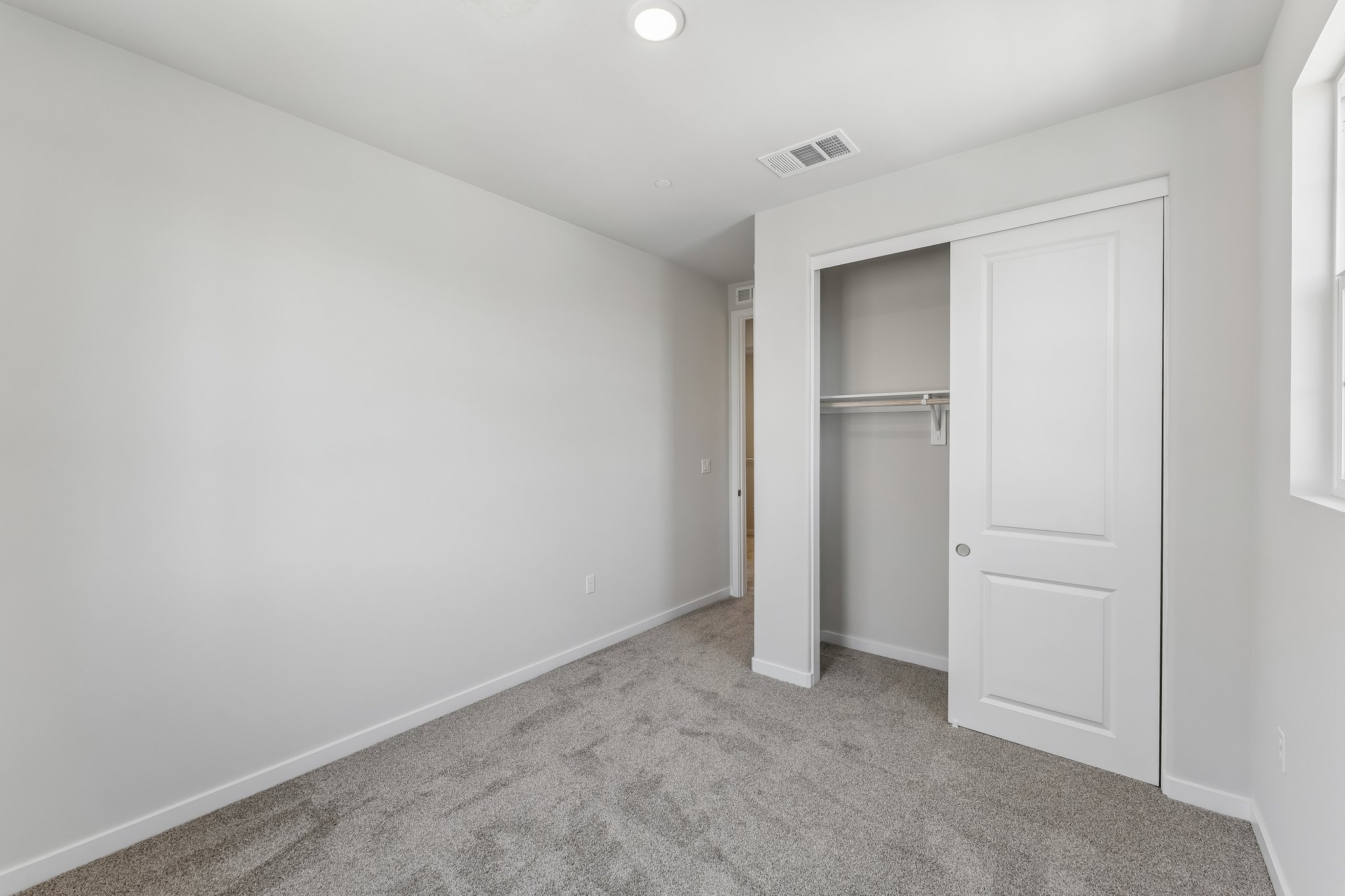 A hallway with white doors.