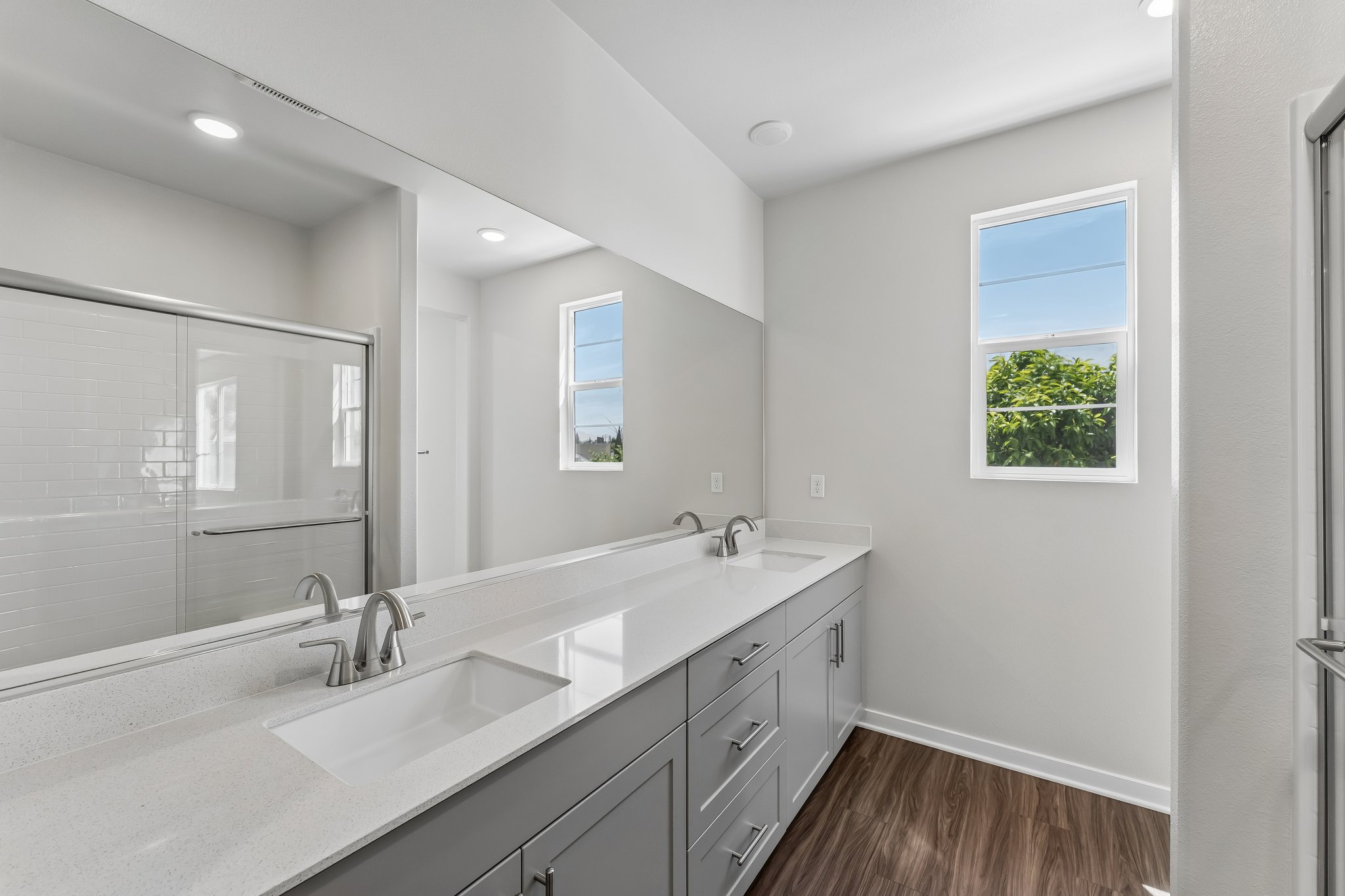 A bathroom with a large mirror.