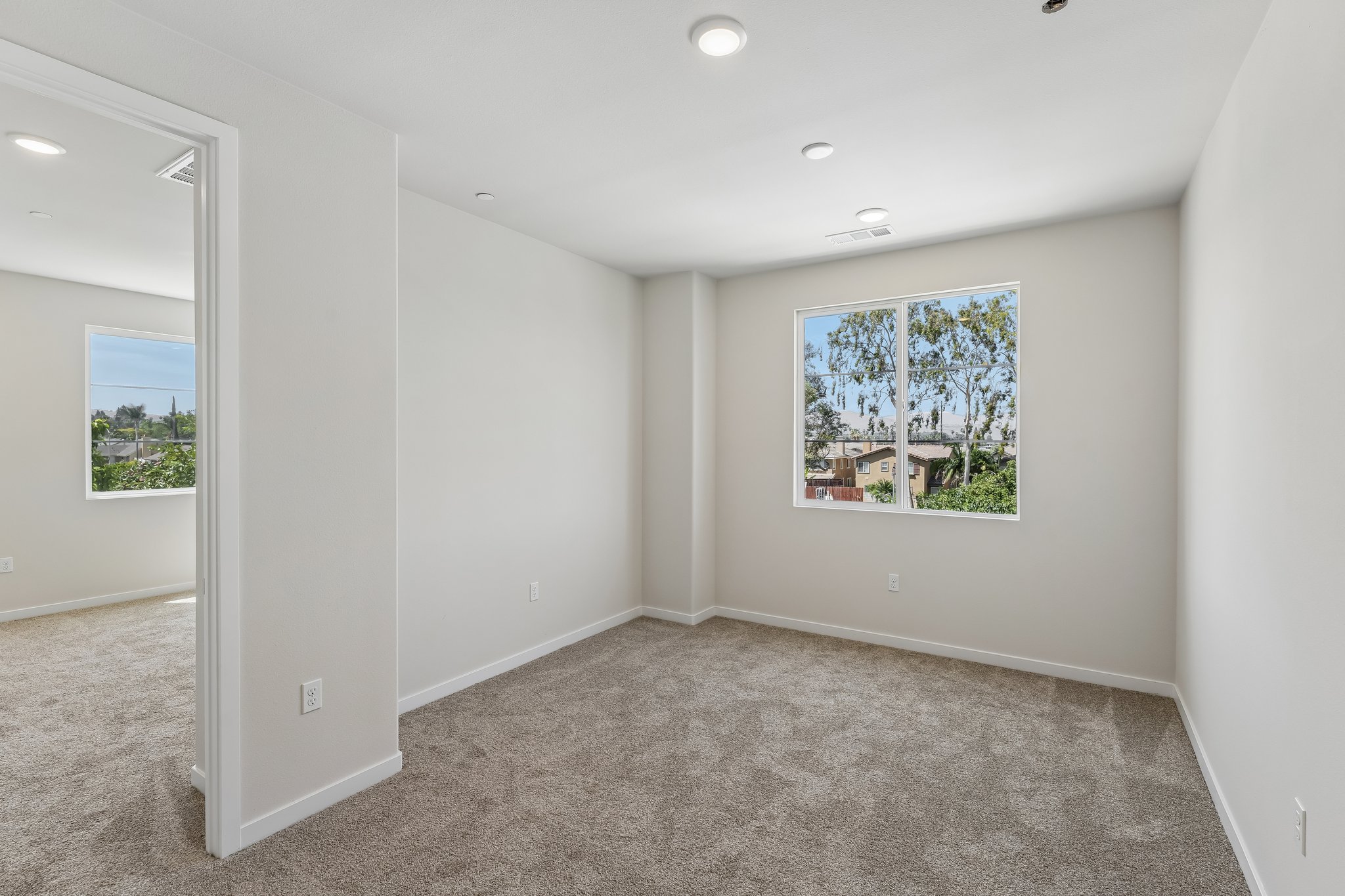 A room with a window and a carpet.