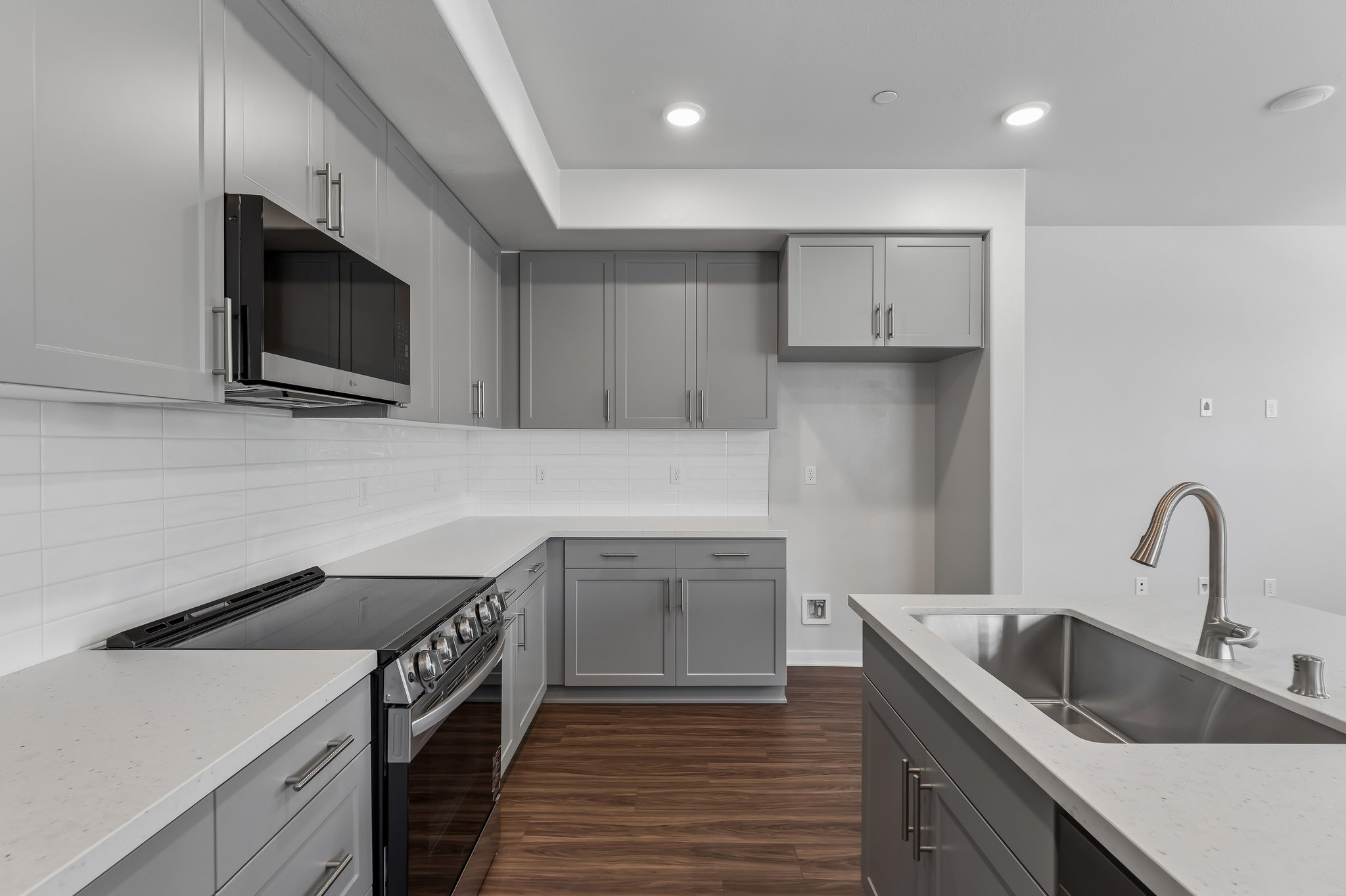 A kitchen with white cabinets.