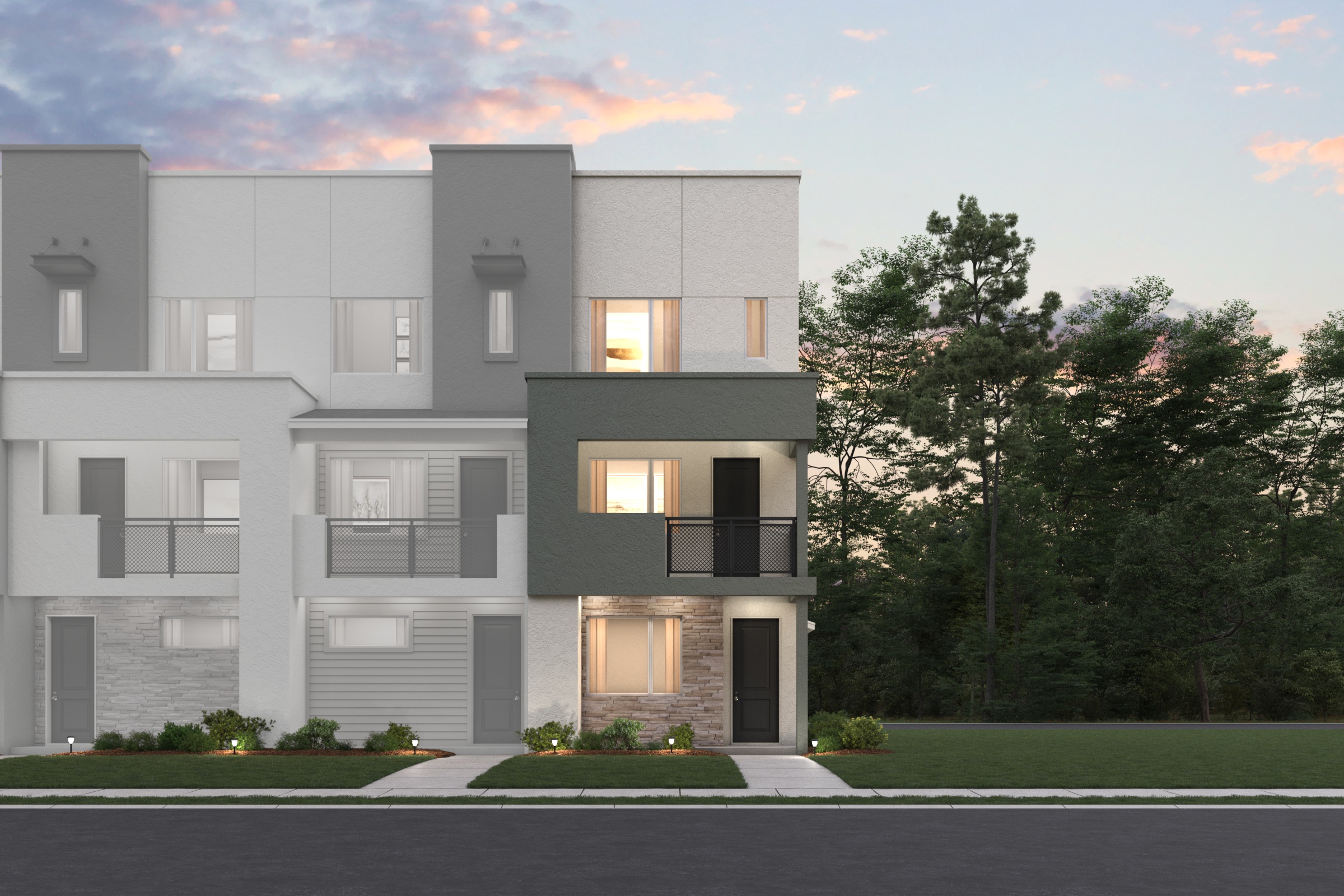 A large grey house with trees in the front.