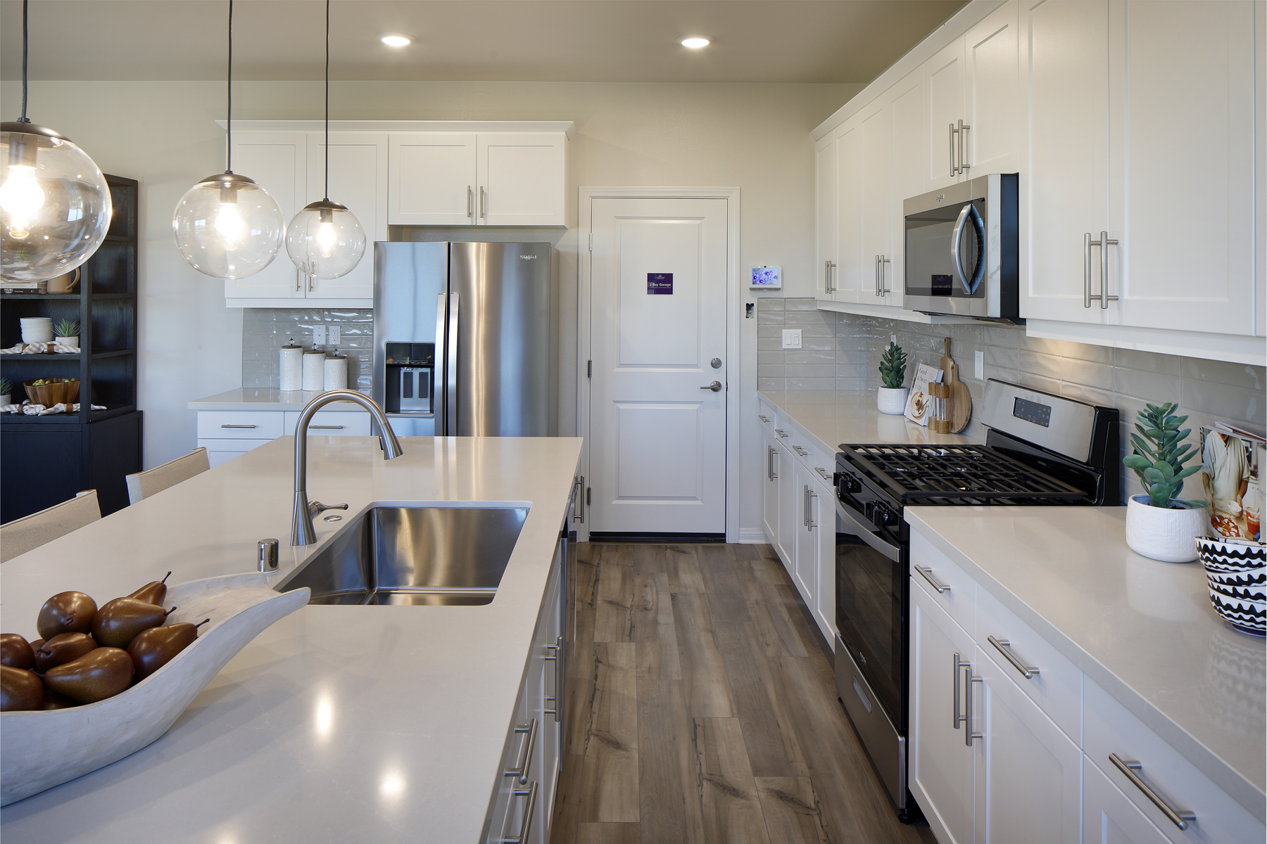 A kitchen with white cabinets.
