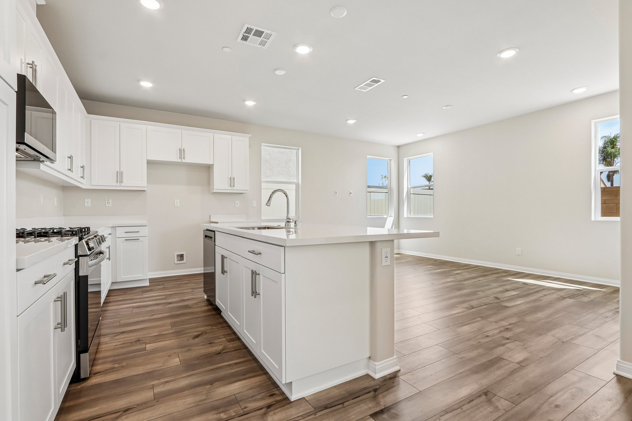 A kitchen with white cabinets.