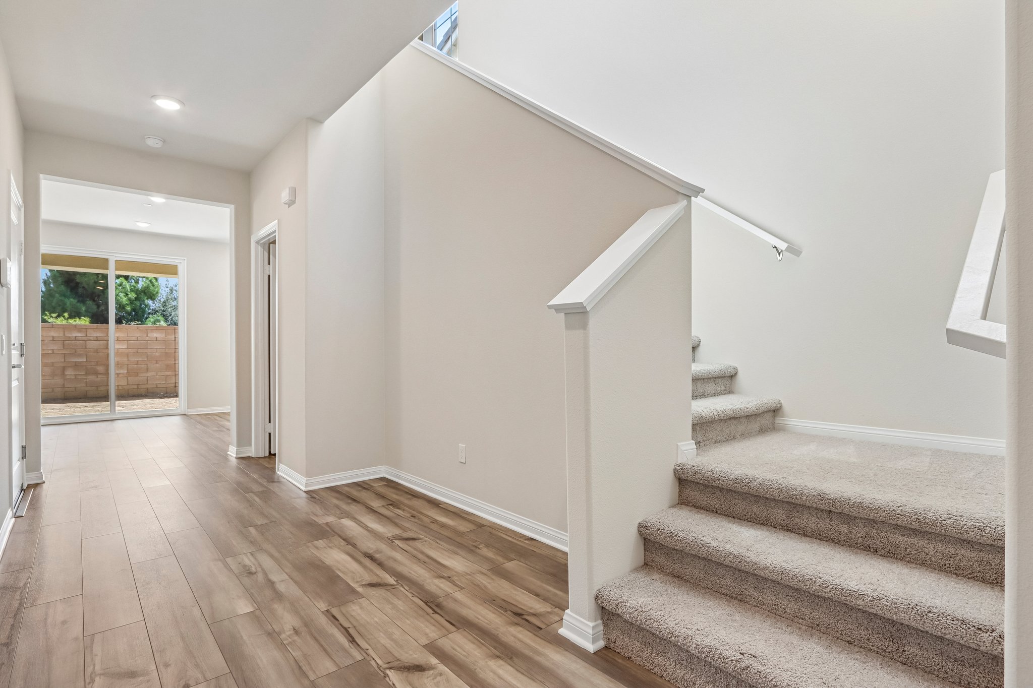A white room with a wood floor.