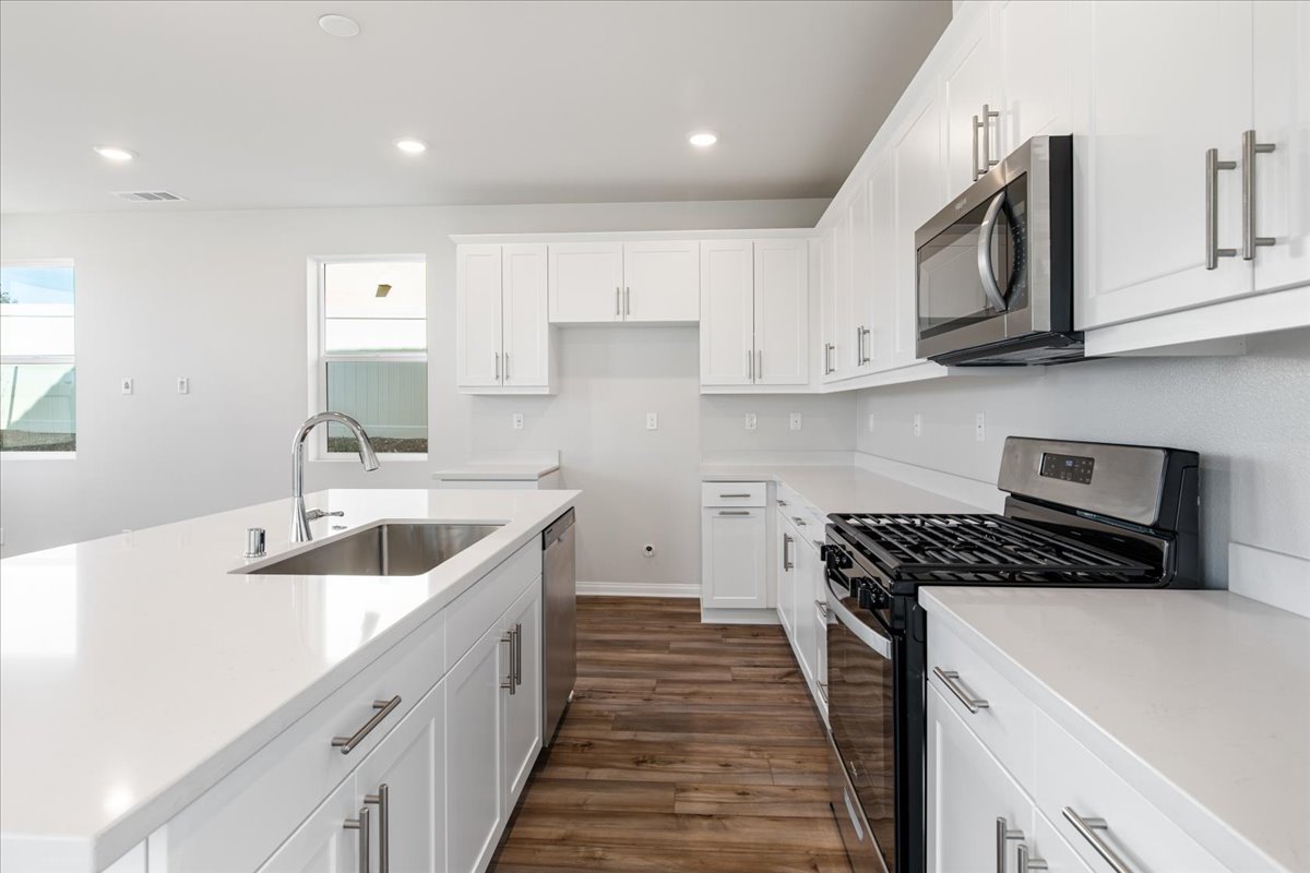 A kitchen with white cabinets.