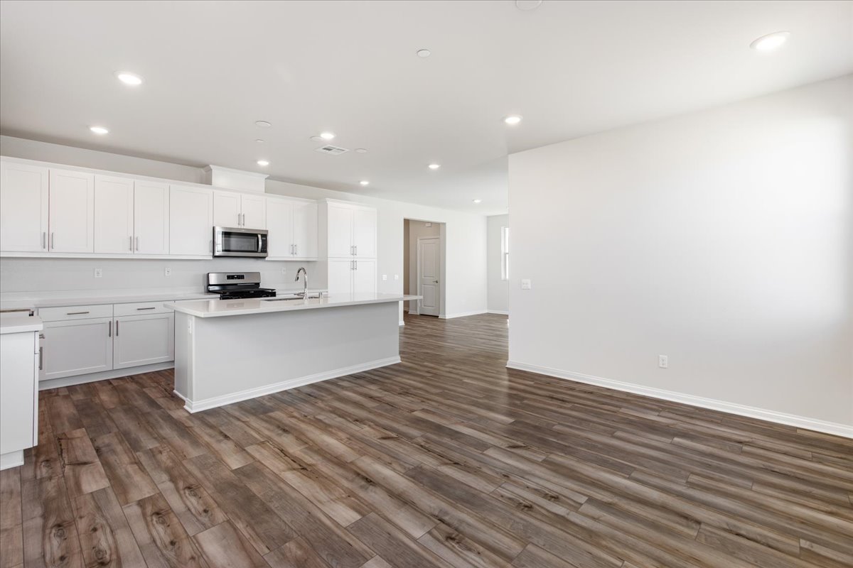 A large kitchen with white cabinets.