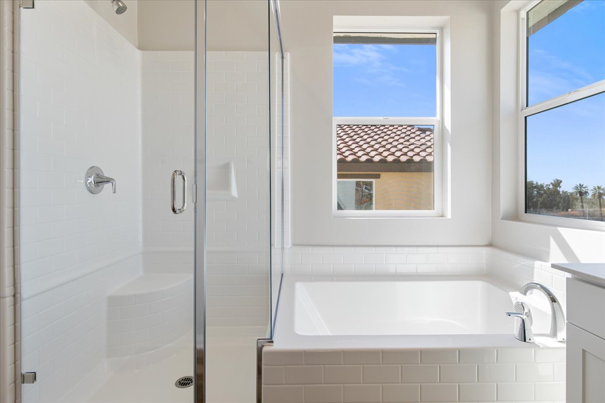 A bathroom with a tub and windows.