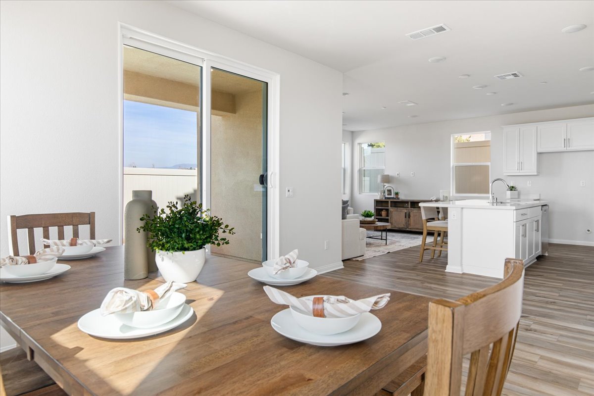 A kitchen with a table and chairs.
