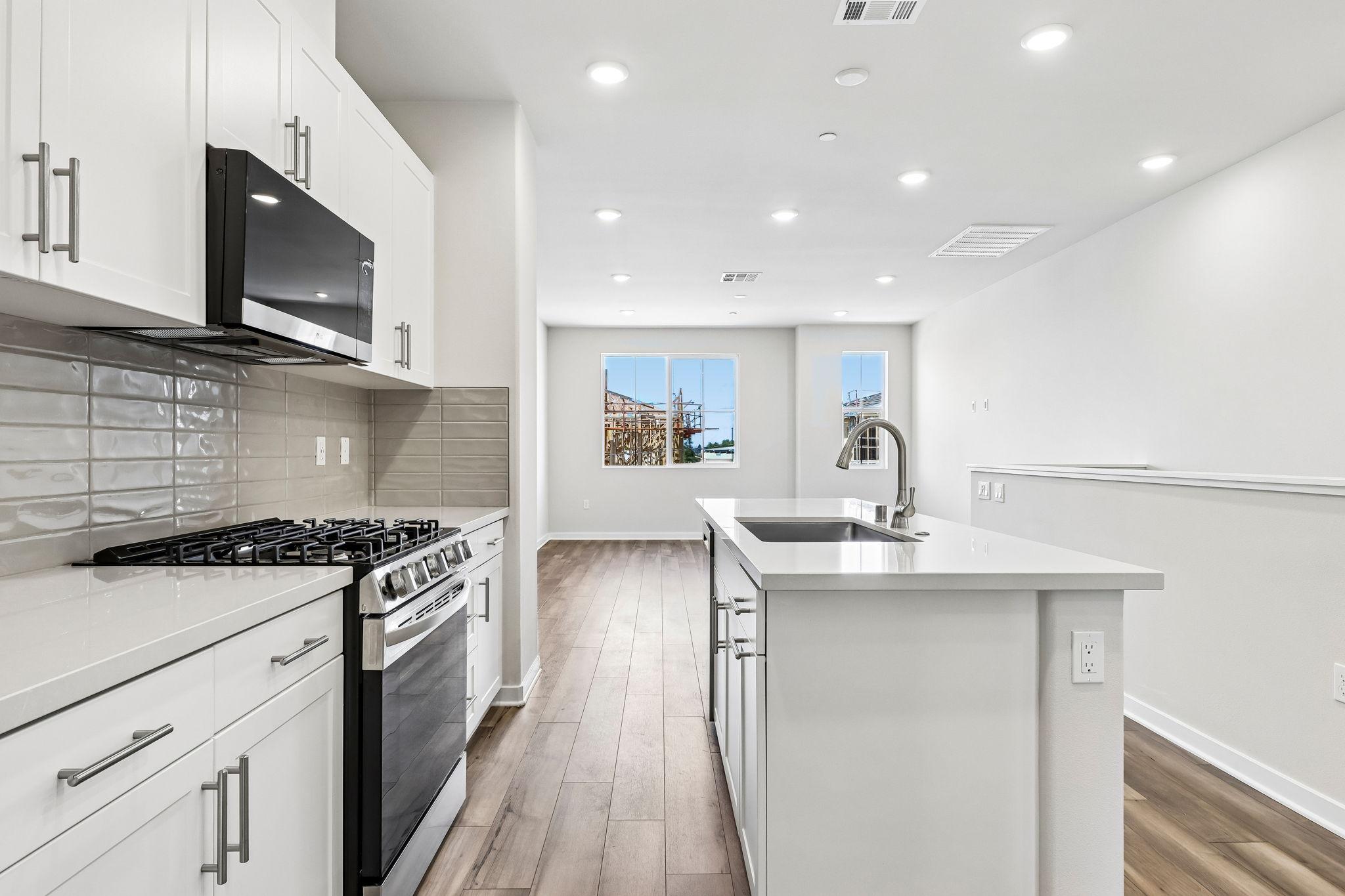 A kitchen with white cabinets.