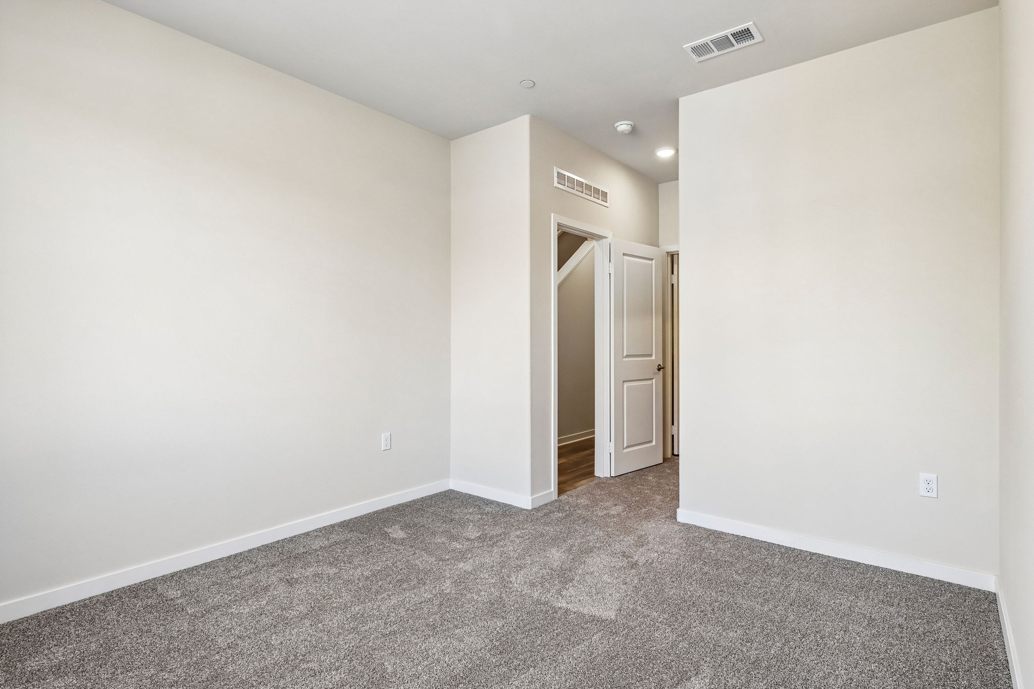 A hallway with white walls.