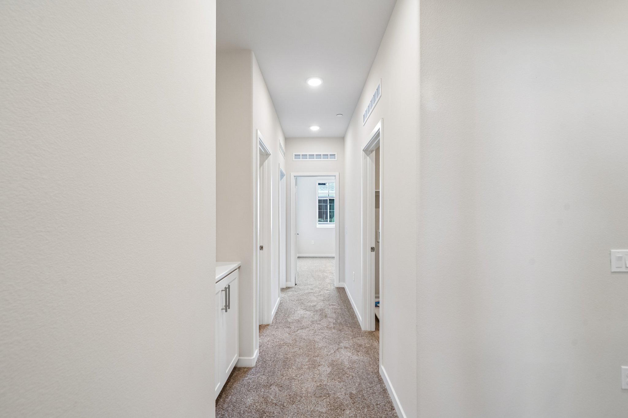 A hallway with white walls.