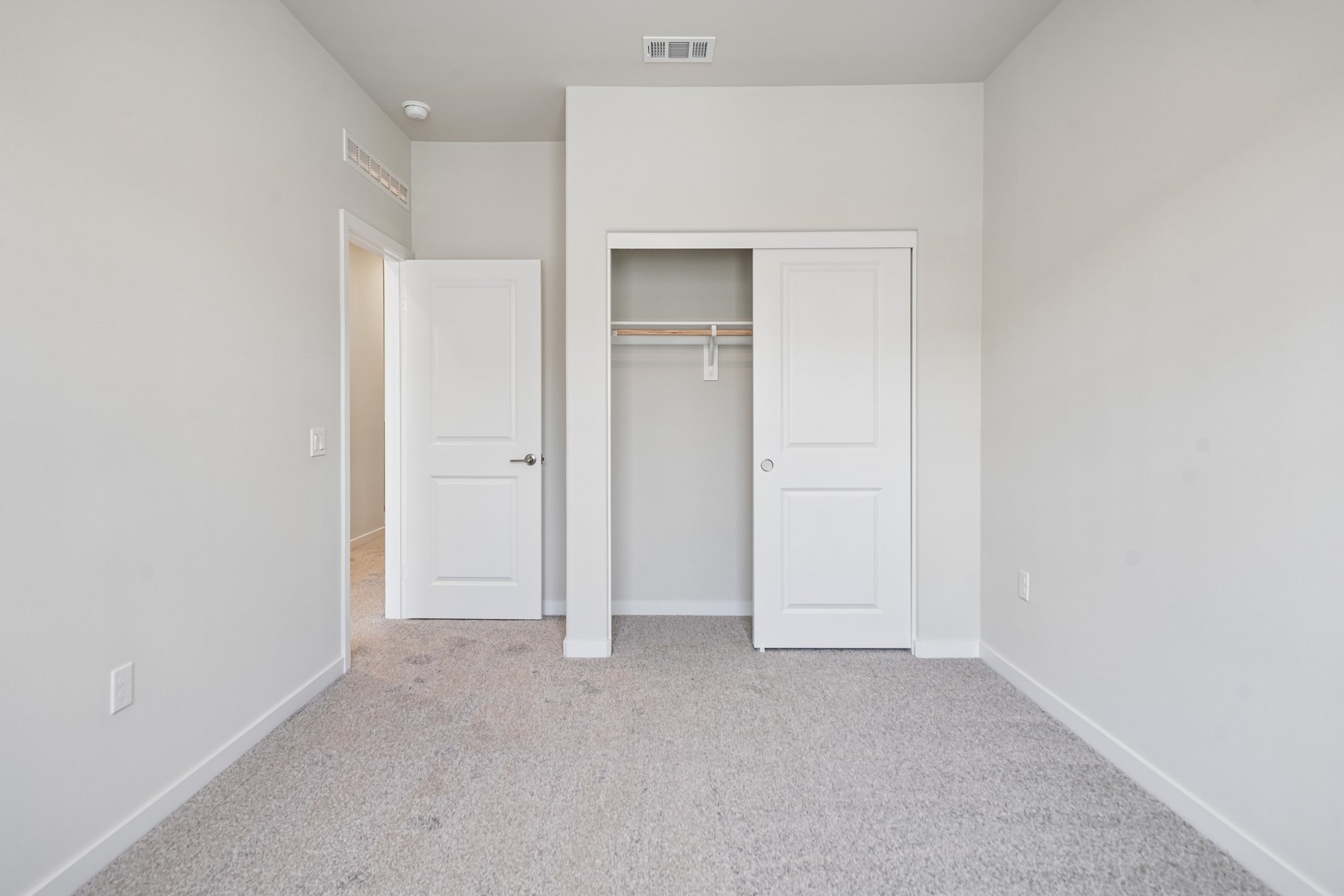 A hallway with white doors.