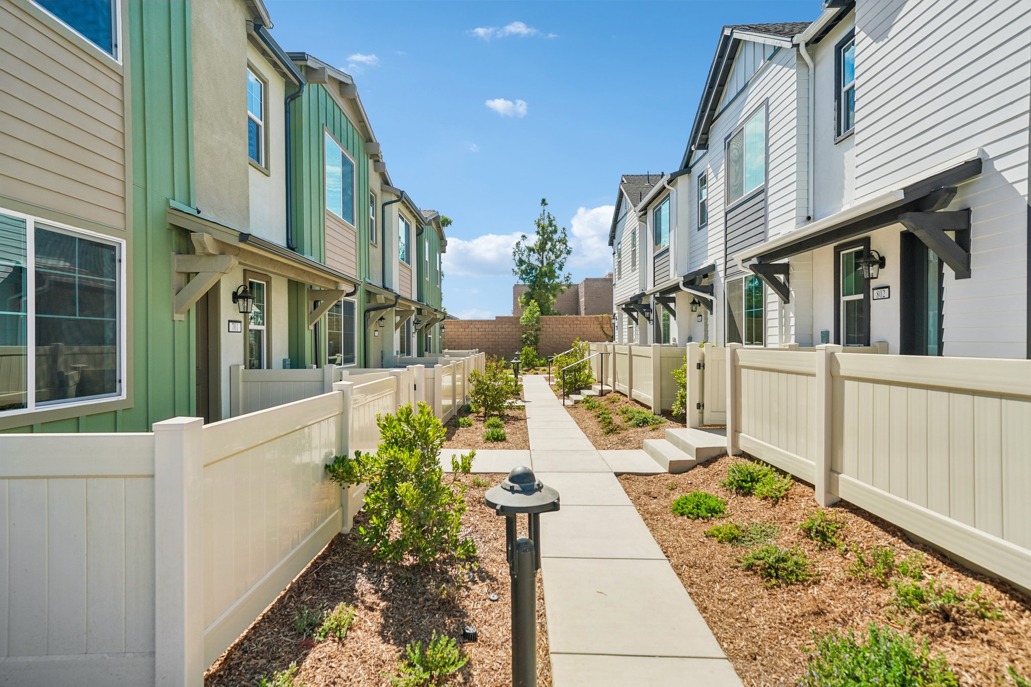 A sidewalk between two buildings.